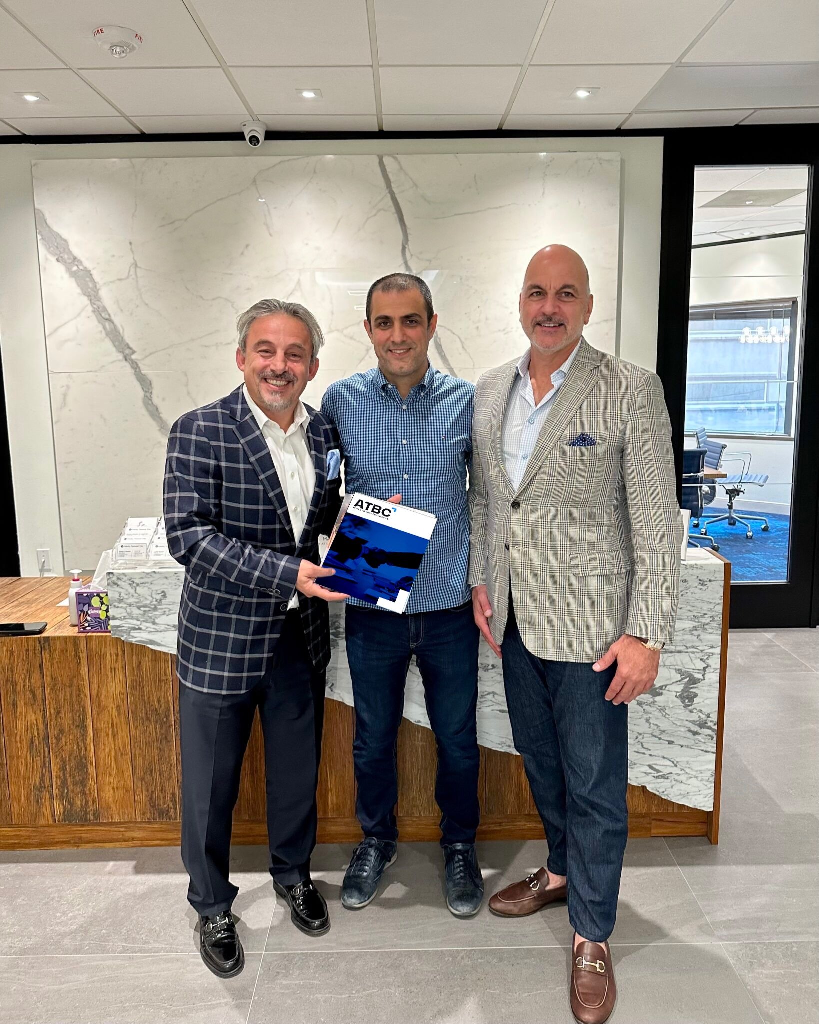 a man in a suit and tie is holding a plaque