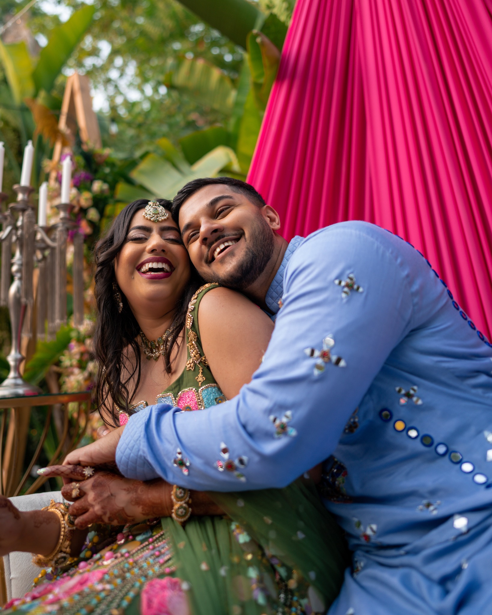 a man and woman in a colorful dress and a man in a blue suit