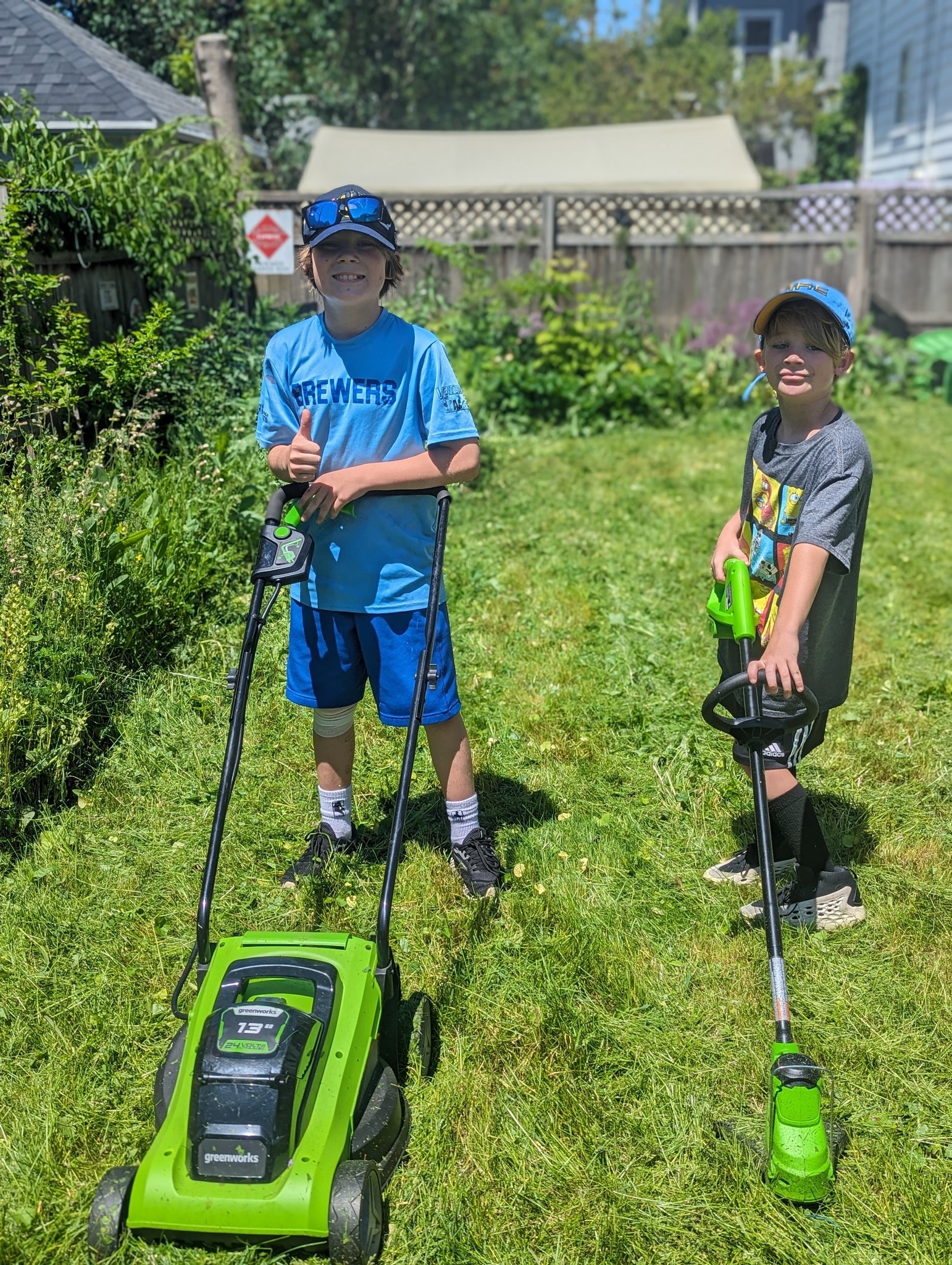 two boys mowing lawns in washington heights