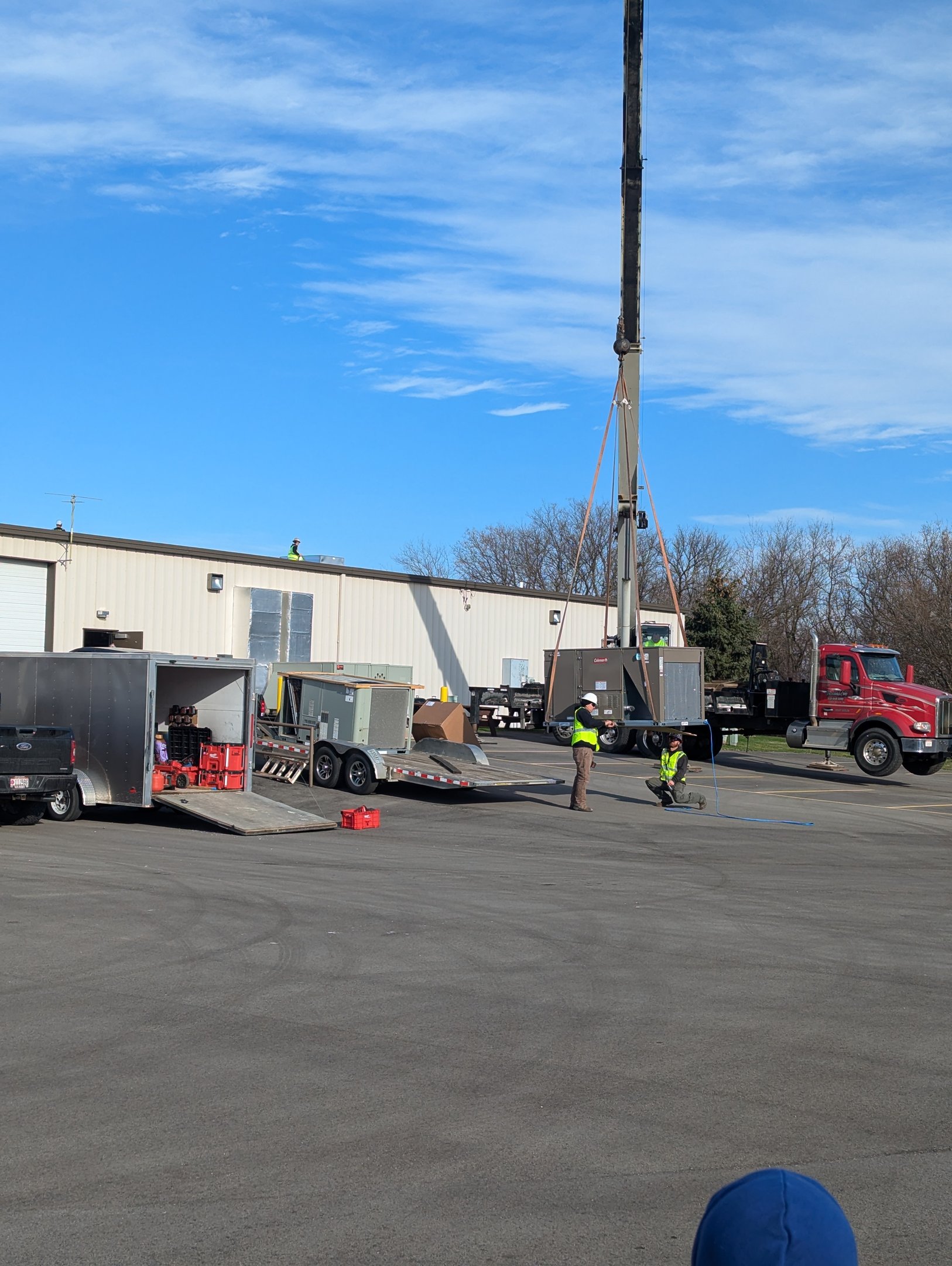 Commercial roof top unit being lifted by a crane by our TRAG HVAC team. No job too big or too small.