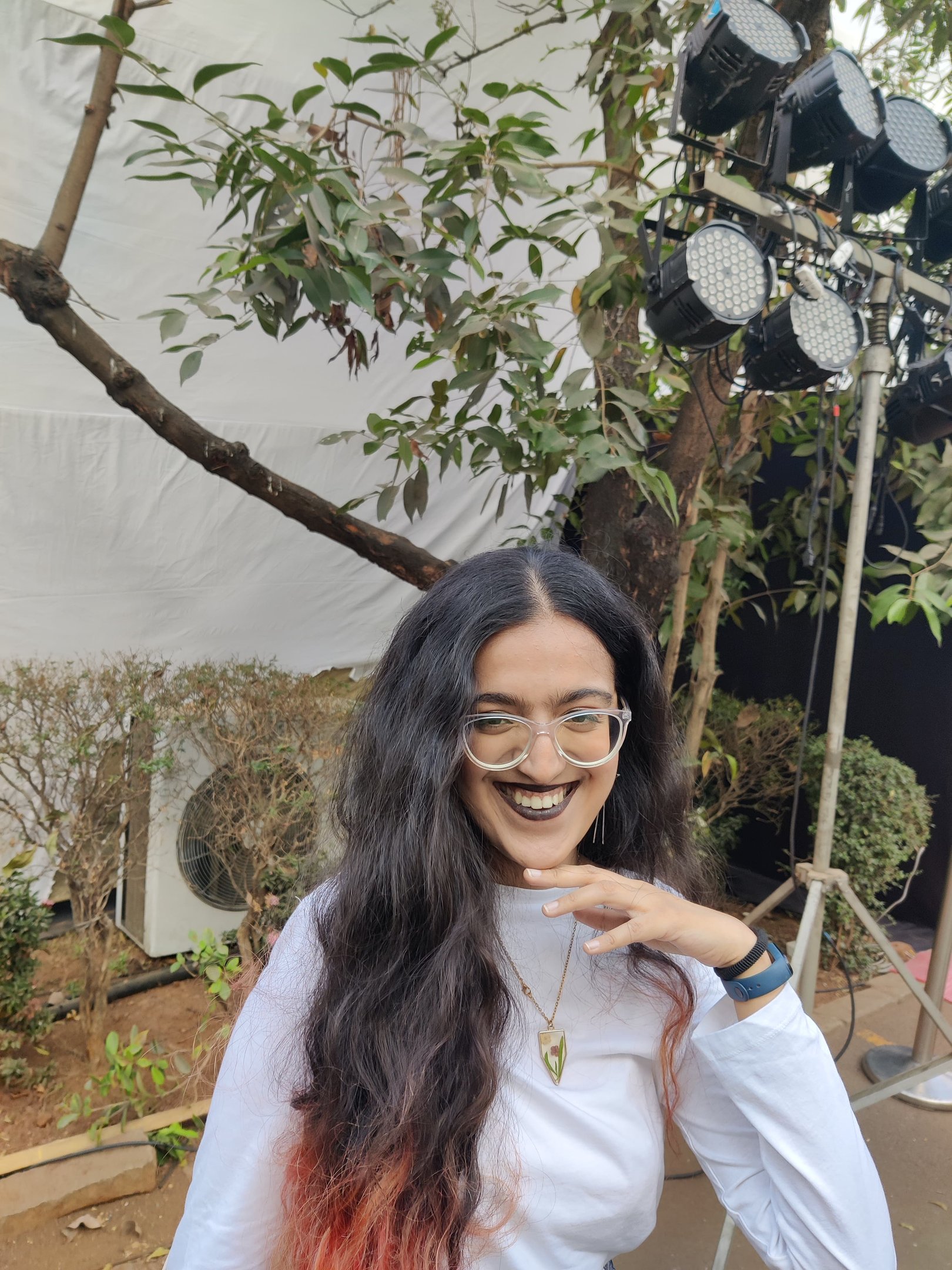 Riya, human copywriter with red streaks at the end of her hair