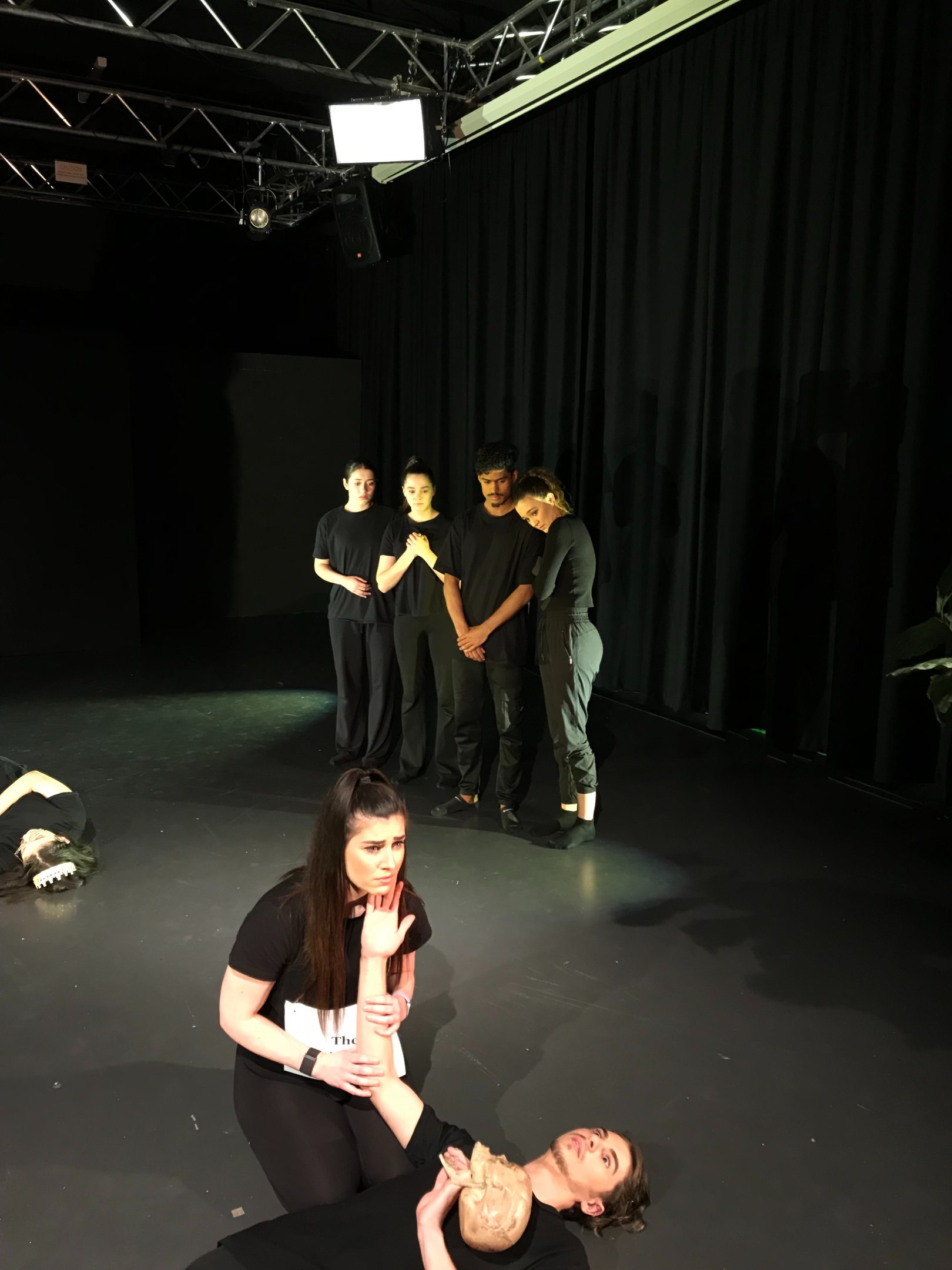 a woman is sitting on a stage with a man and a woman