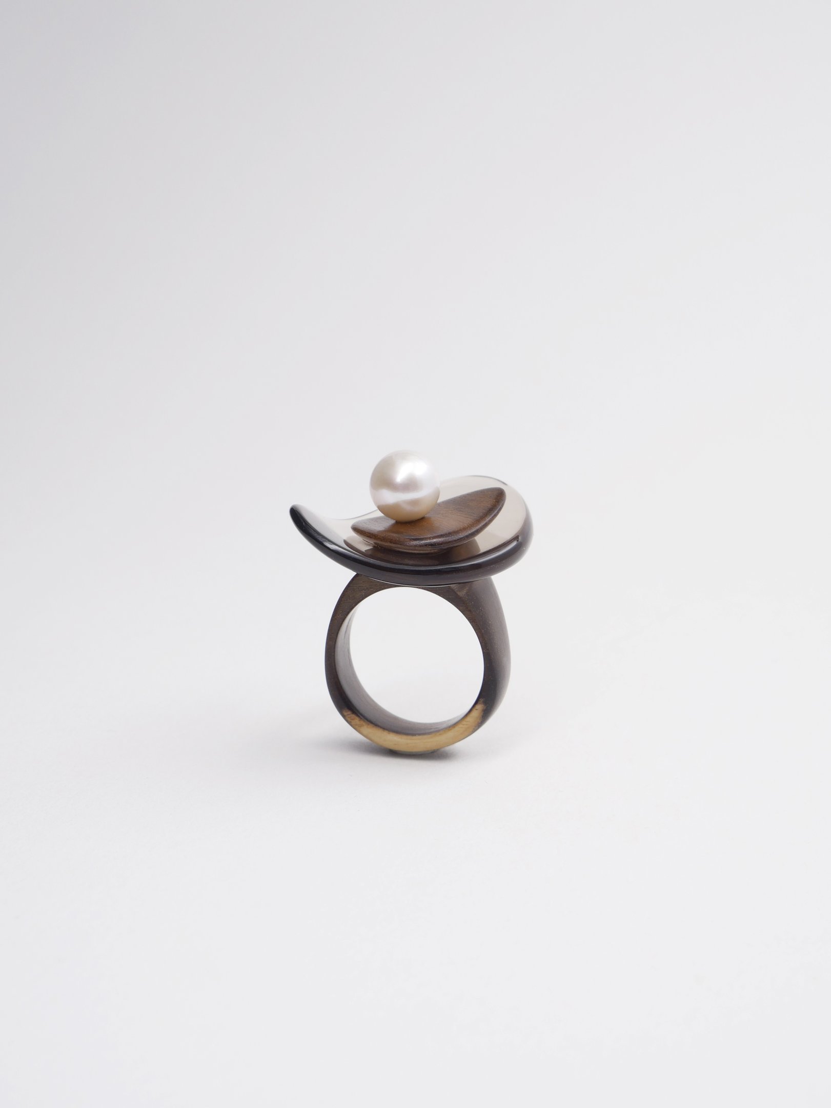Handcrafted horn ring with a white pearl accent on a minimalist sculptural setting.
