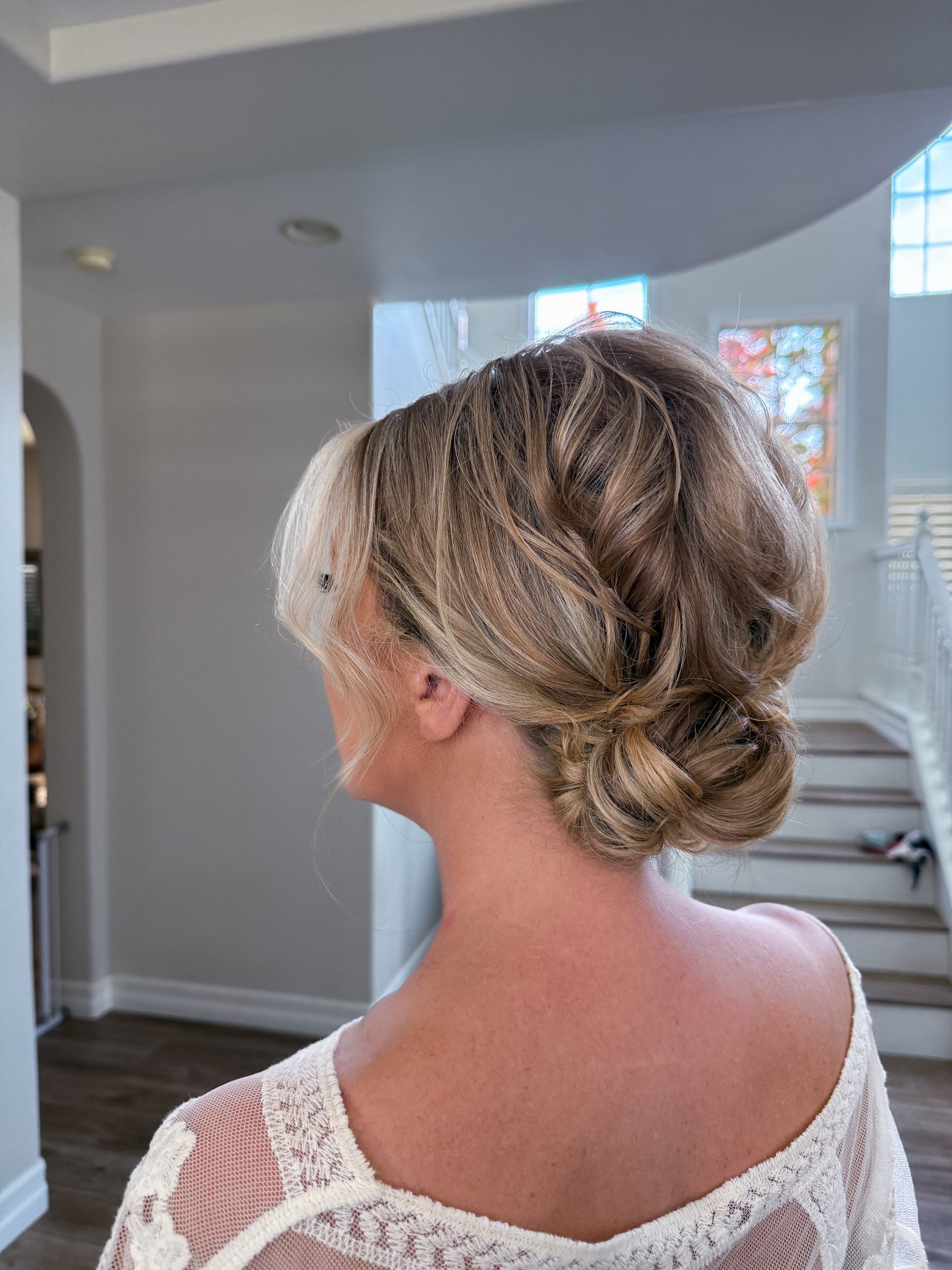 Lodi winery wedding featuring romantic low bun with face-framing tendrils