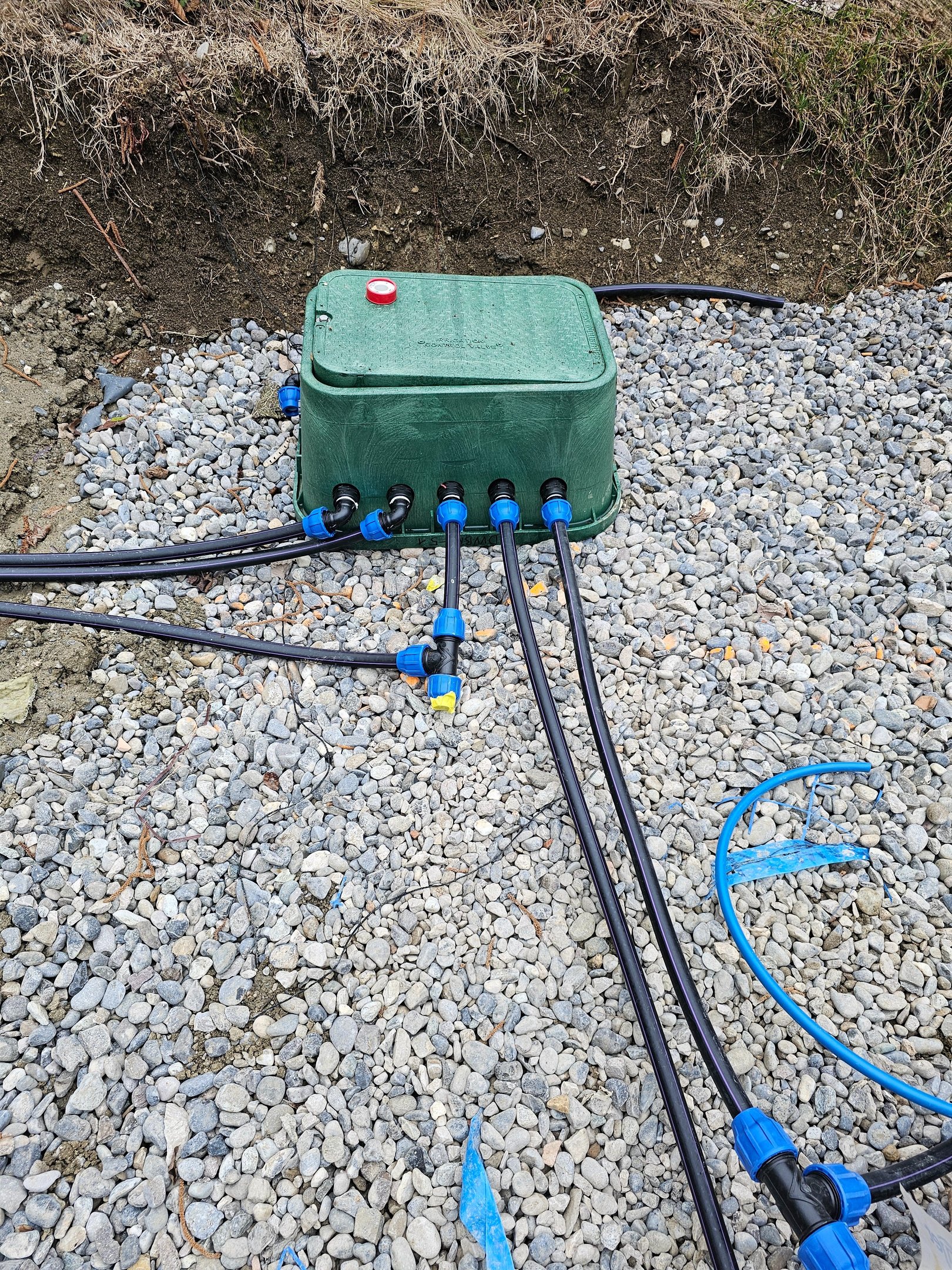 solenoid valve manhole with gravel bottom and outlet pipes