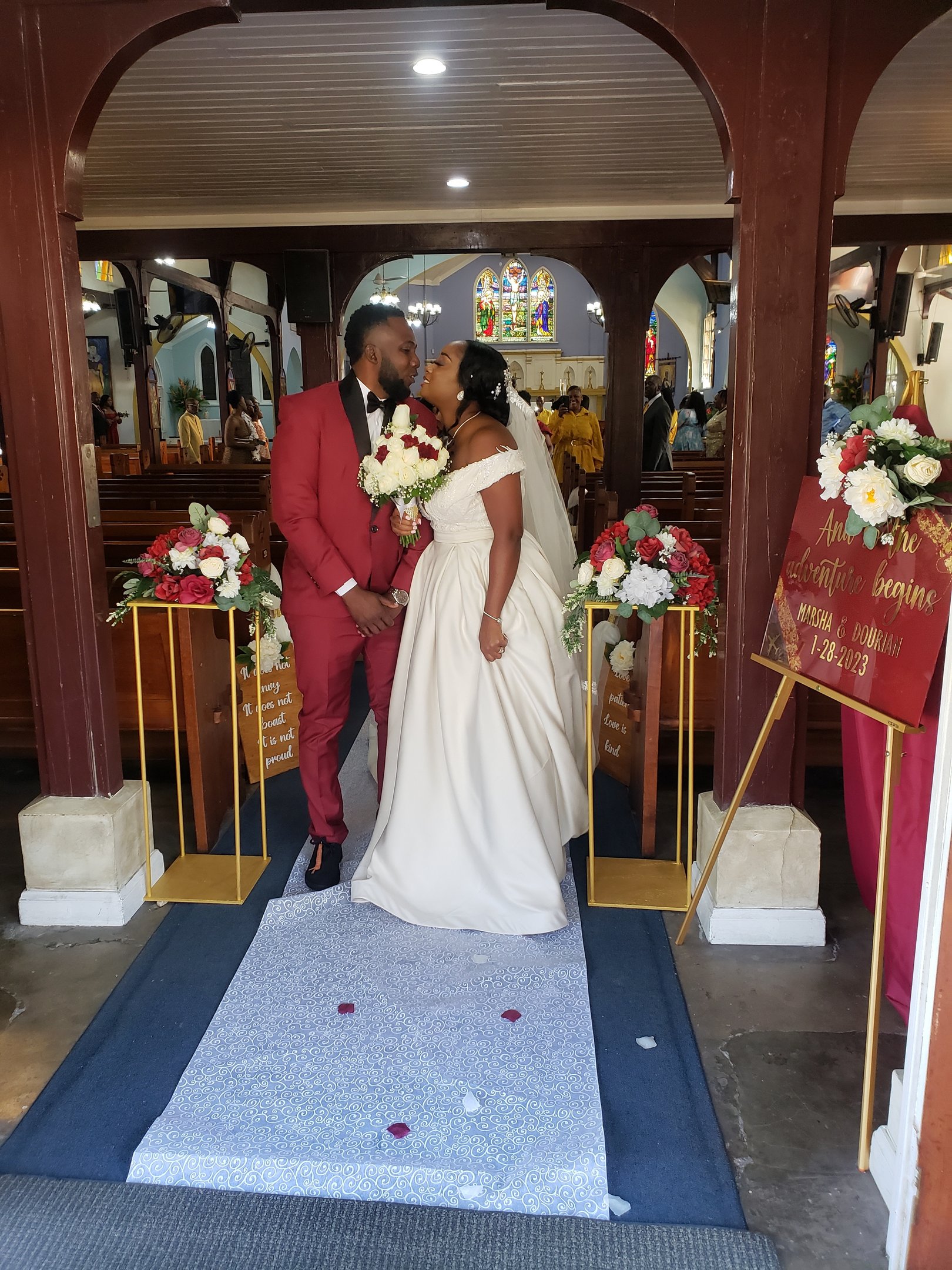 a bride and groom standing in front of a church