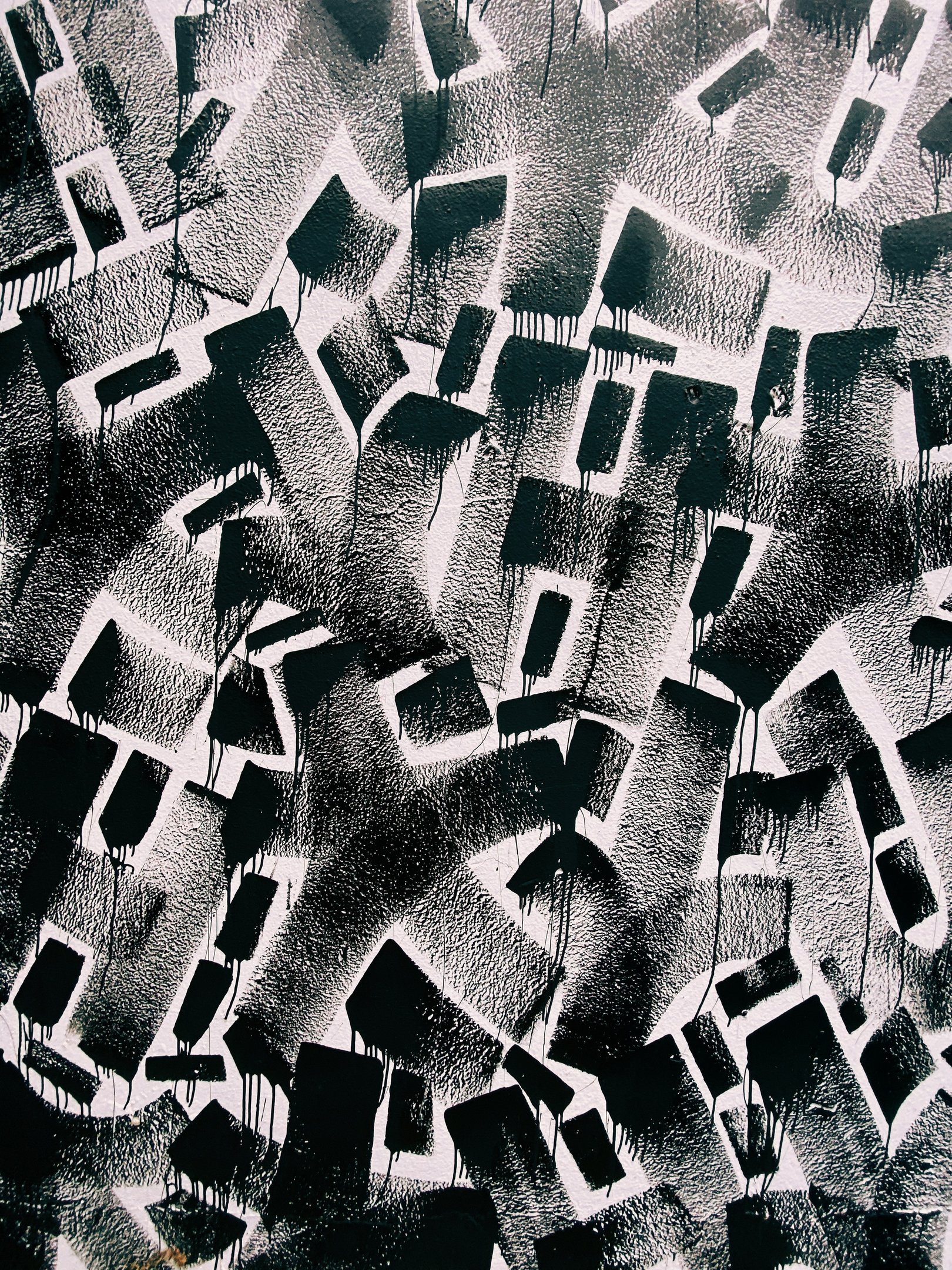 a black and white photograph of a graffiti filled wall