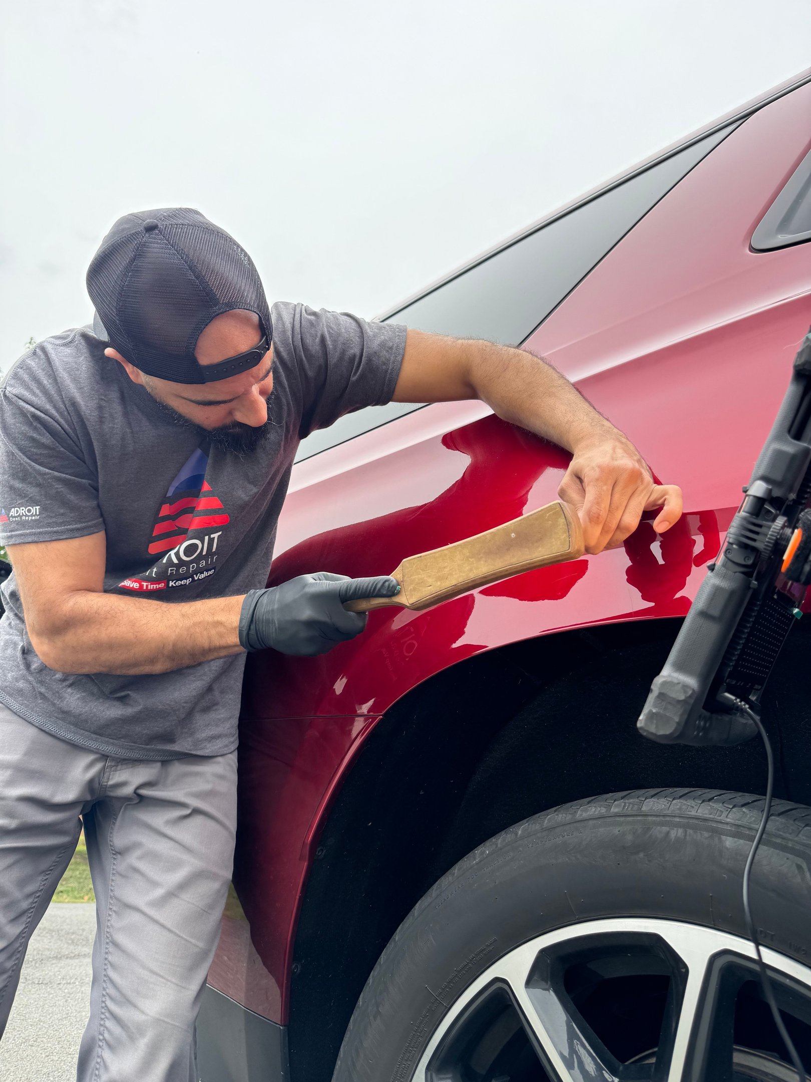 Mr. Sam knocking down a Tahoe to fix a ding