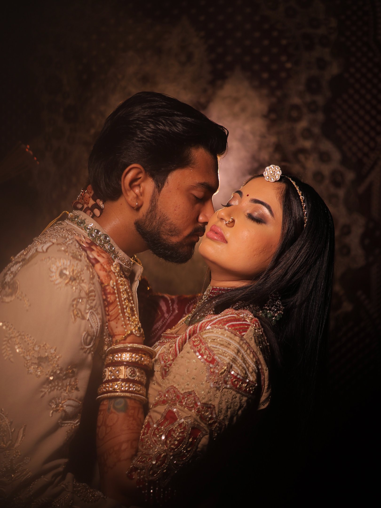 Close-up portrait of an Indian bride showcasing beautiful smokey eye makeup, a flawless base, and tr