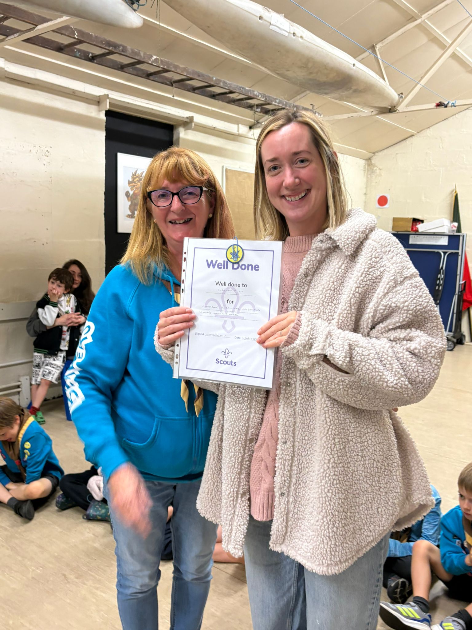 A certificate has been awarded by a beavers leader to Christine for painting the 25th Allerton Scout Hut