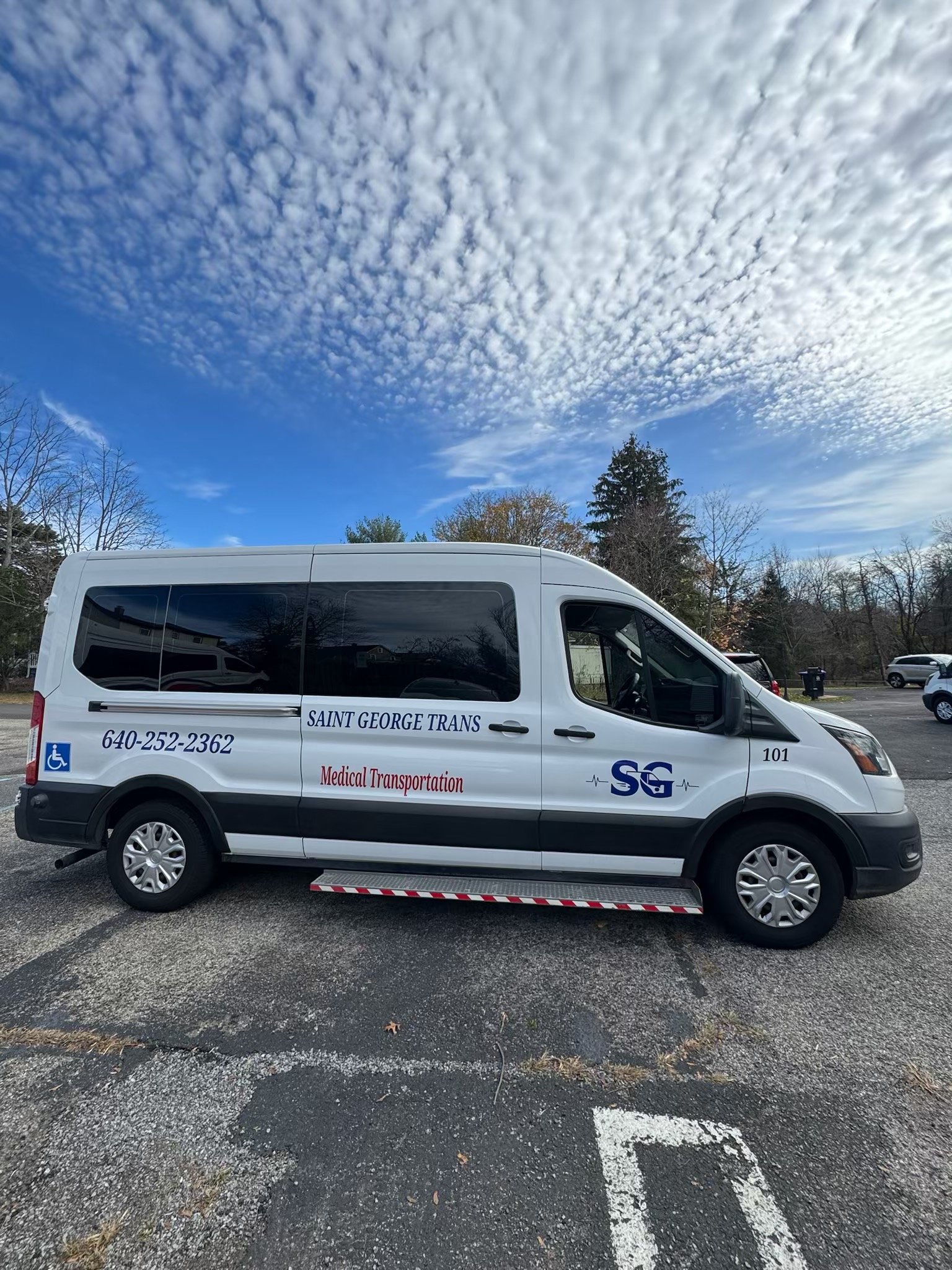 Saint George Trans white non-emergency medical transportation van for handicap accessible patient transport.