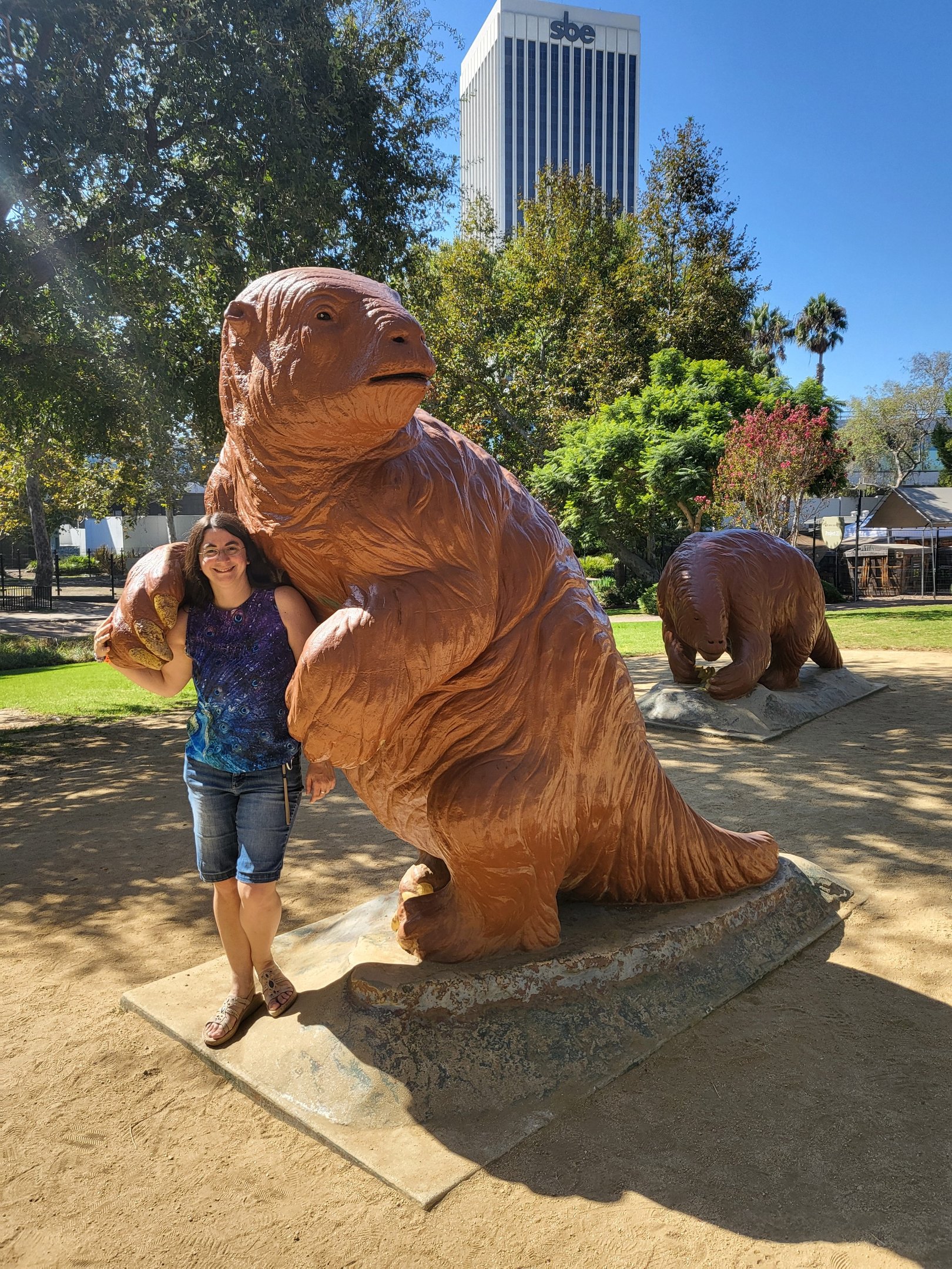 Andrielle with giant ground sloth statue