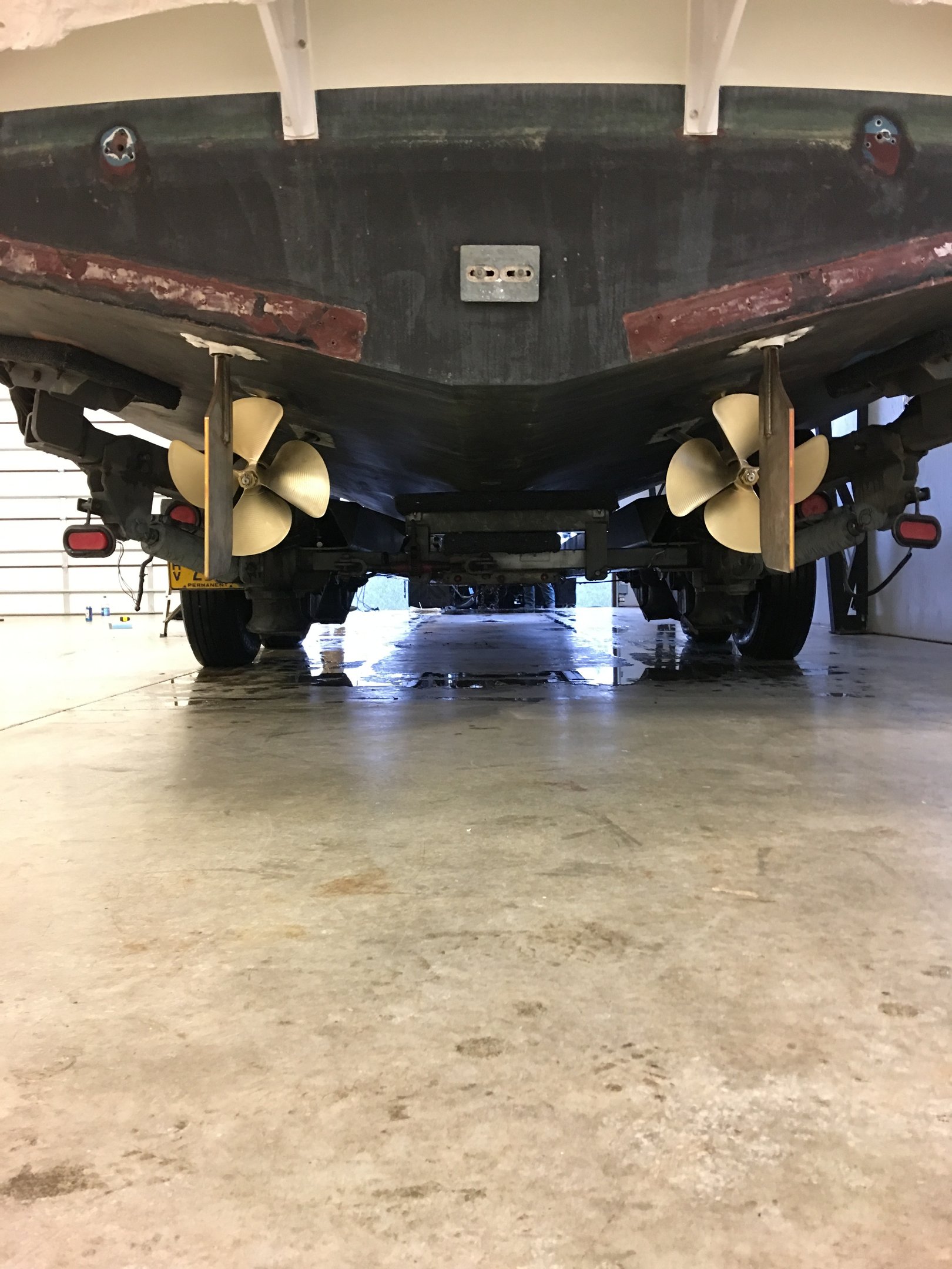 a large boat sitting in a garage props rudders