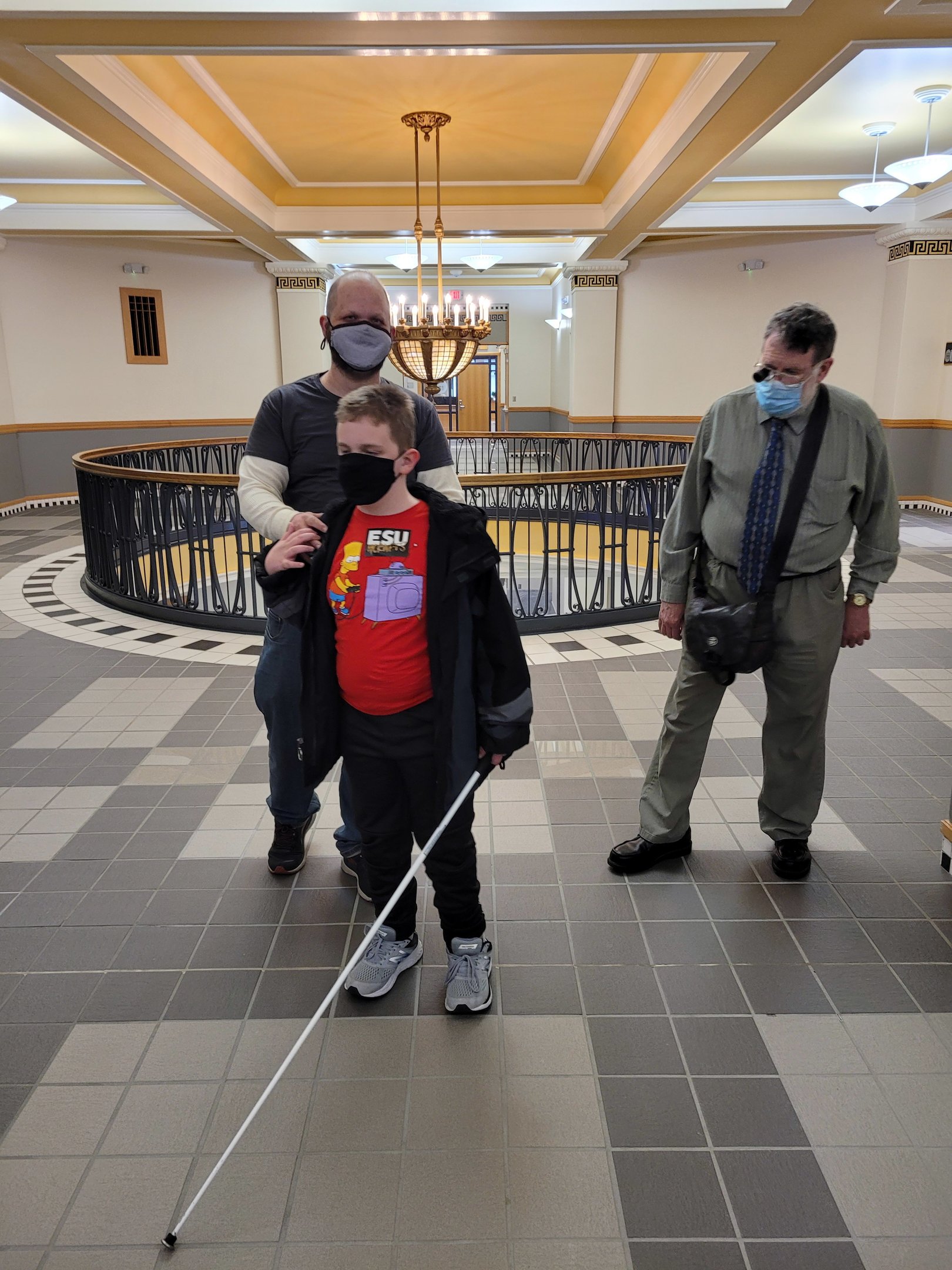 KABVI member assisting a young man with orientation and mobility training