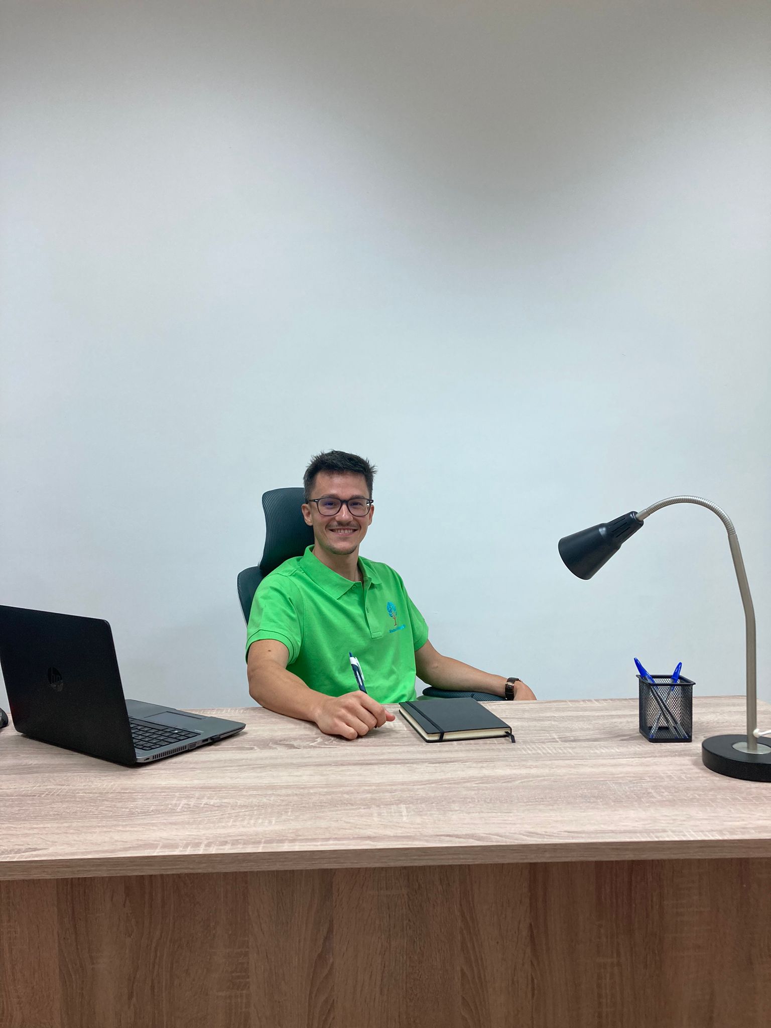 a man sitting at a desk with a laptop and a laptop