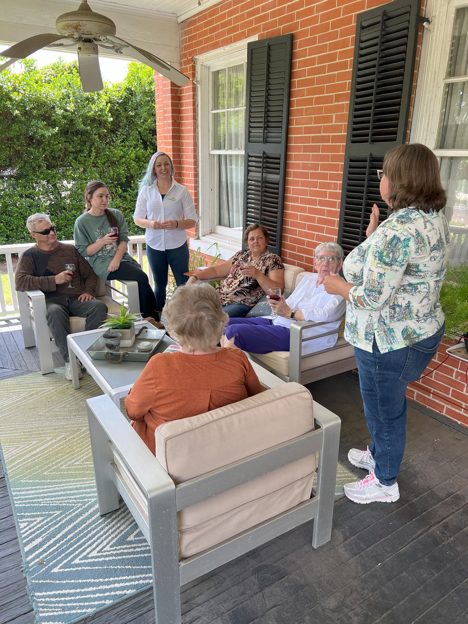 a group of people sitting on a porch