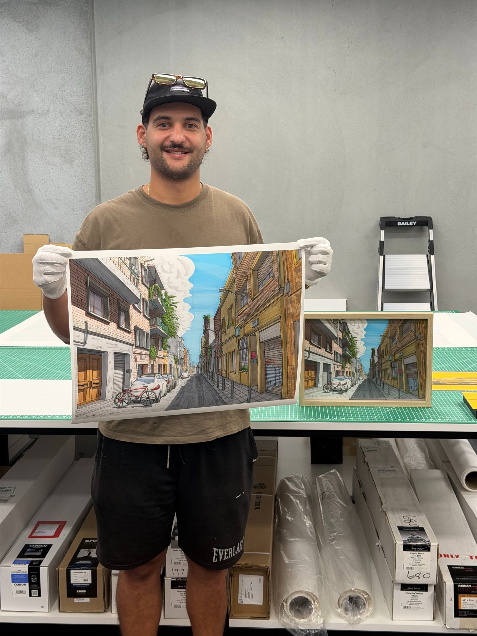 Artist holding an urban street art canvas print in a professional print studio