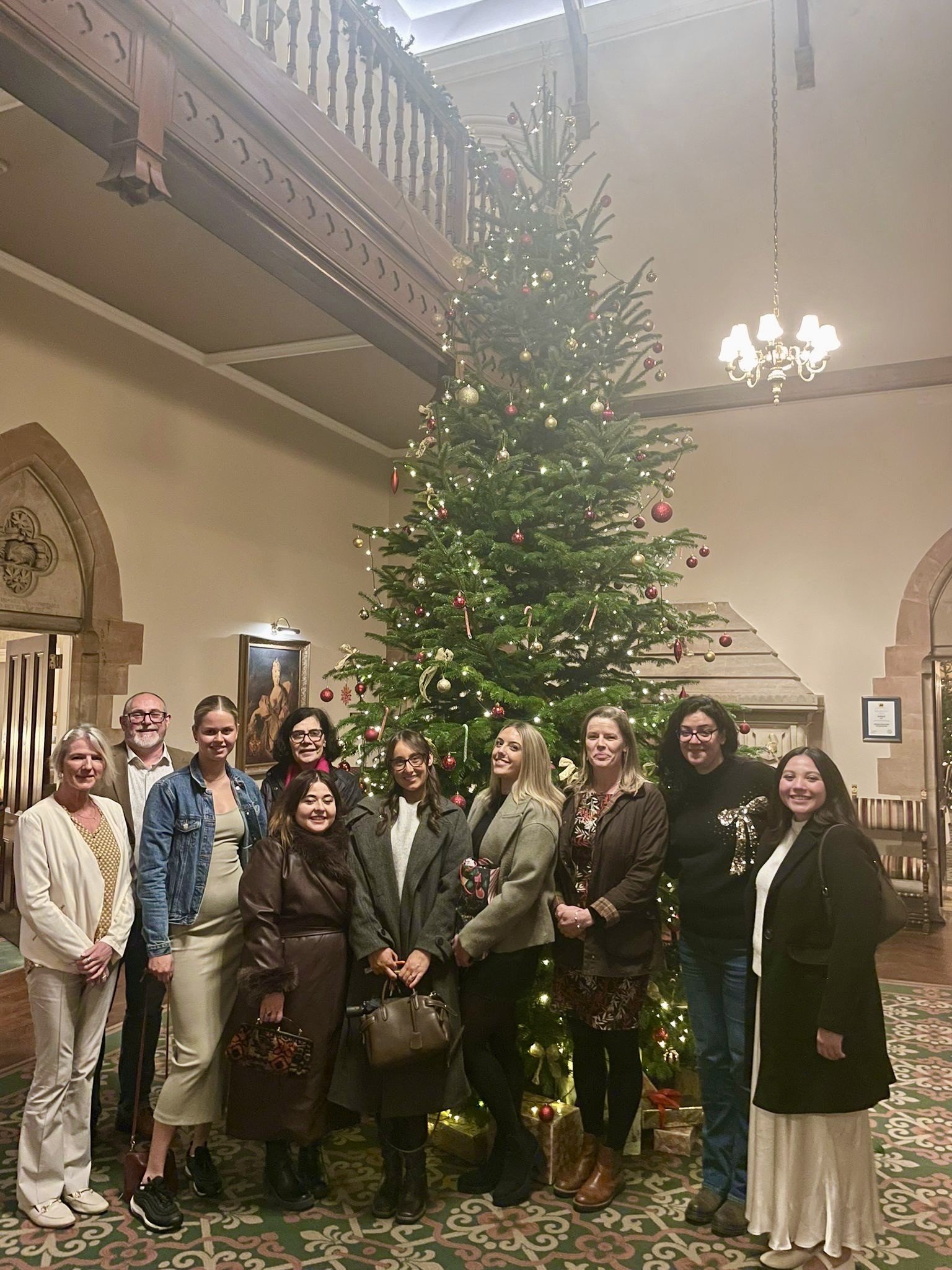 Claire Nash Solicitors team standing by a decorated Christmas tree