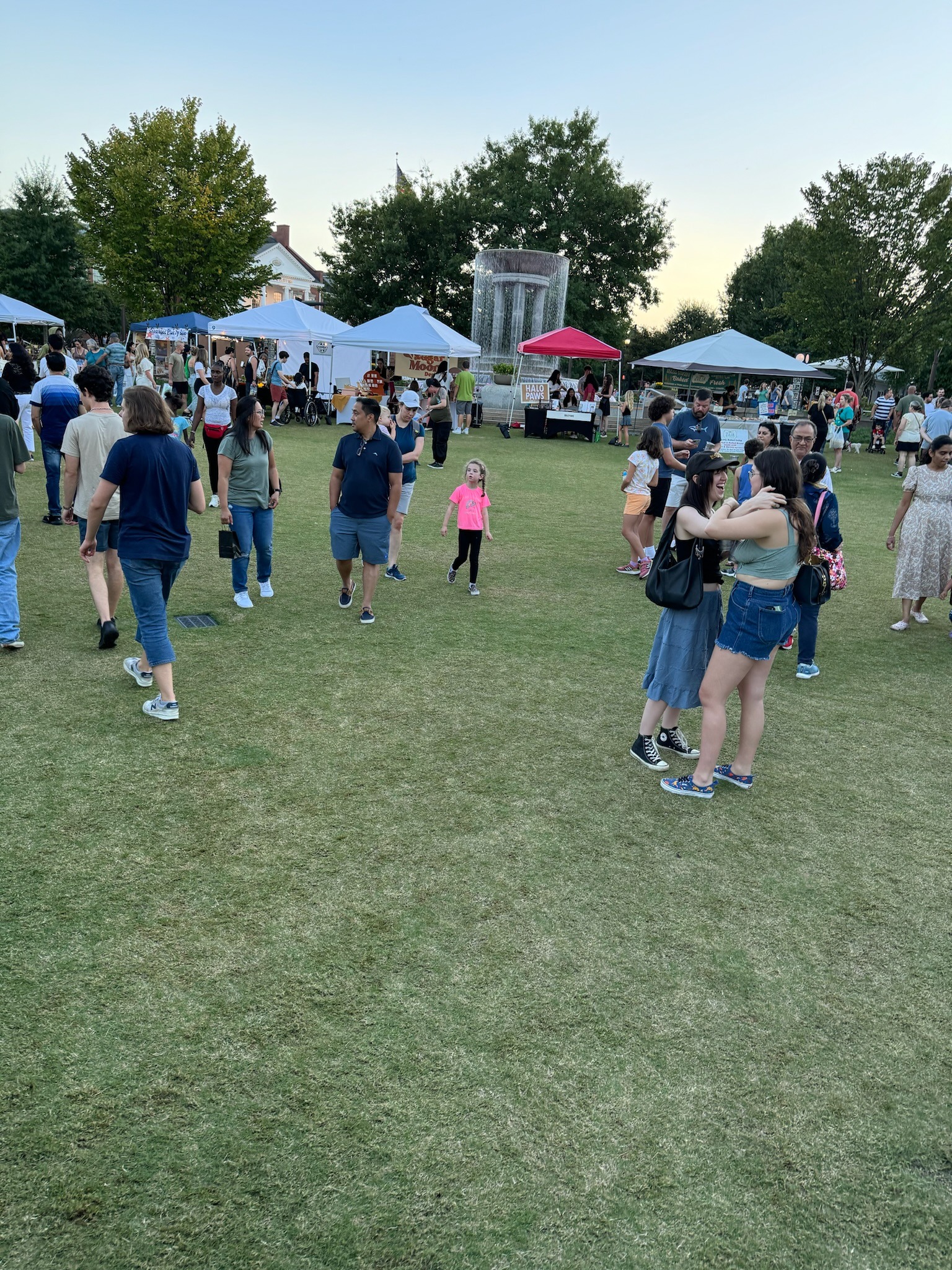 Families, kids, and community members enjoying nice weather at a market