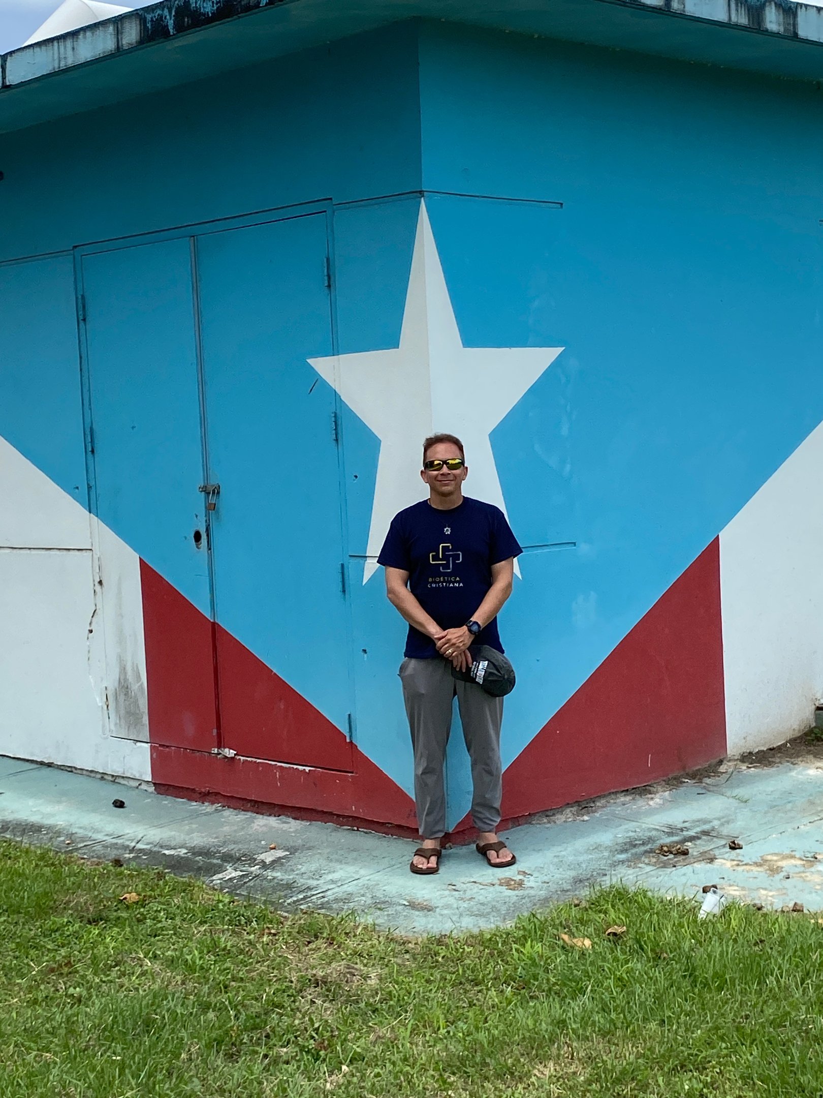 a man standing in front of a building with a large star on it