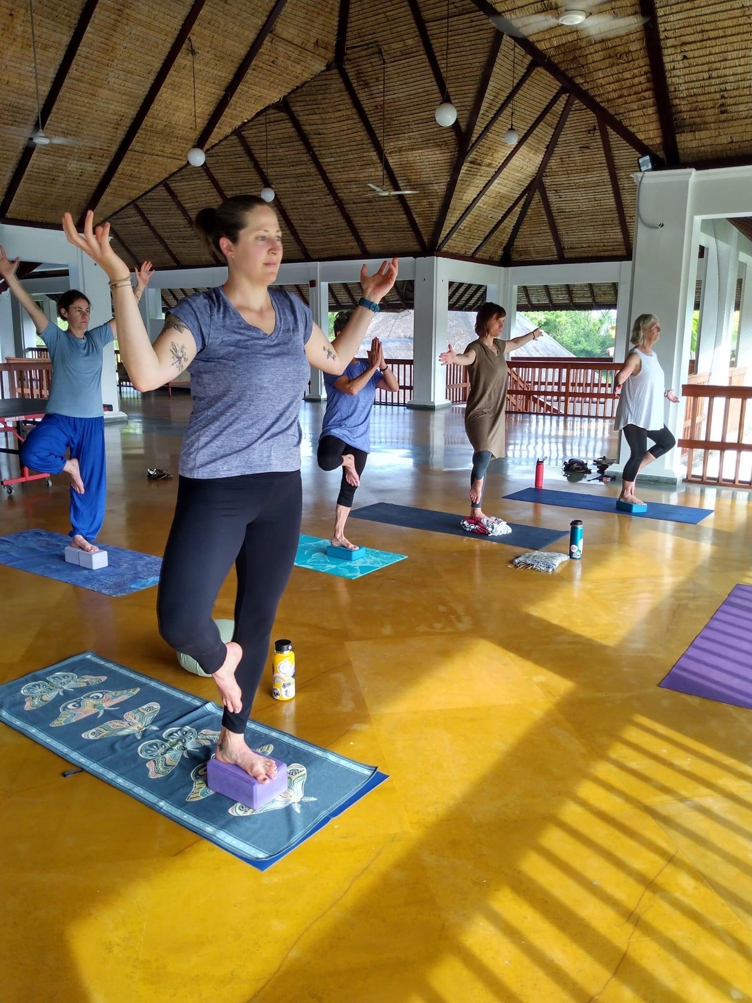 a woman in a yoga pose with a yoga mat