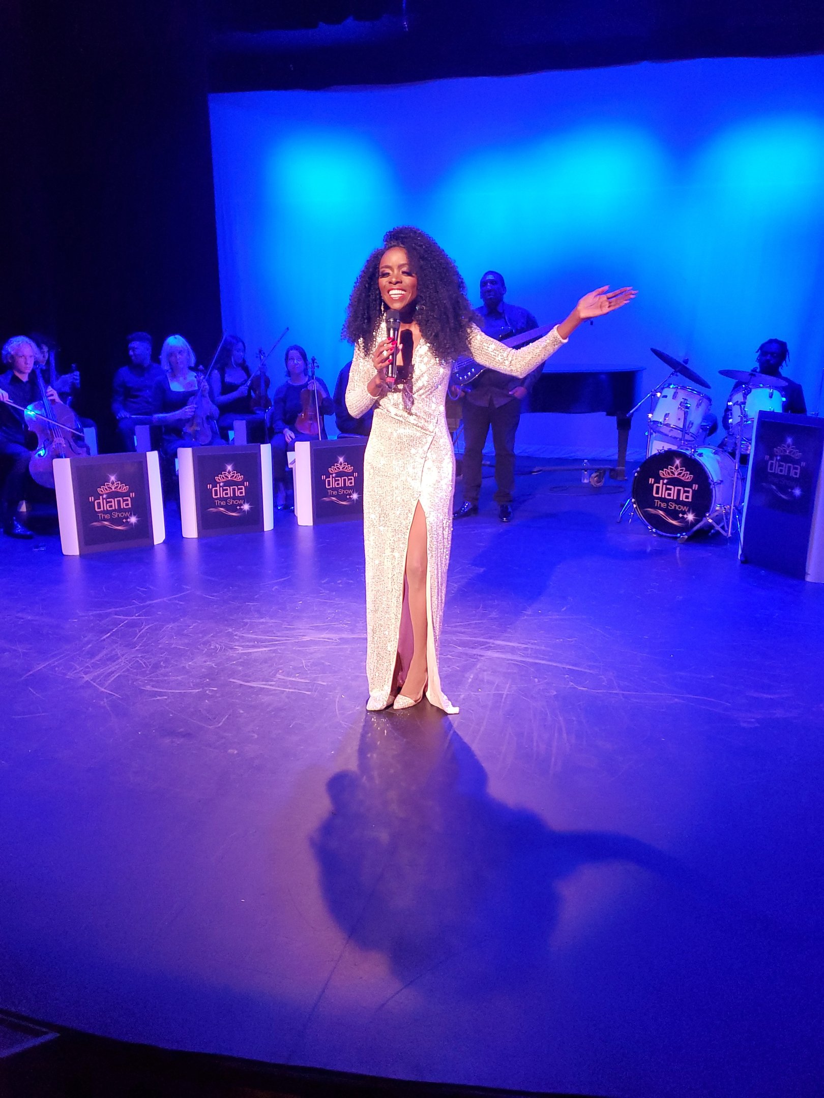 a woman in a white dress standing on a stage