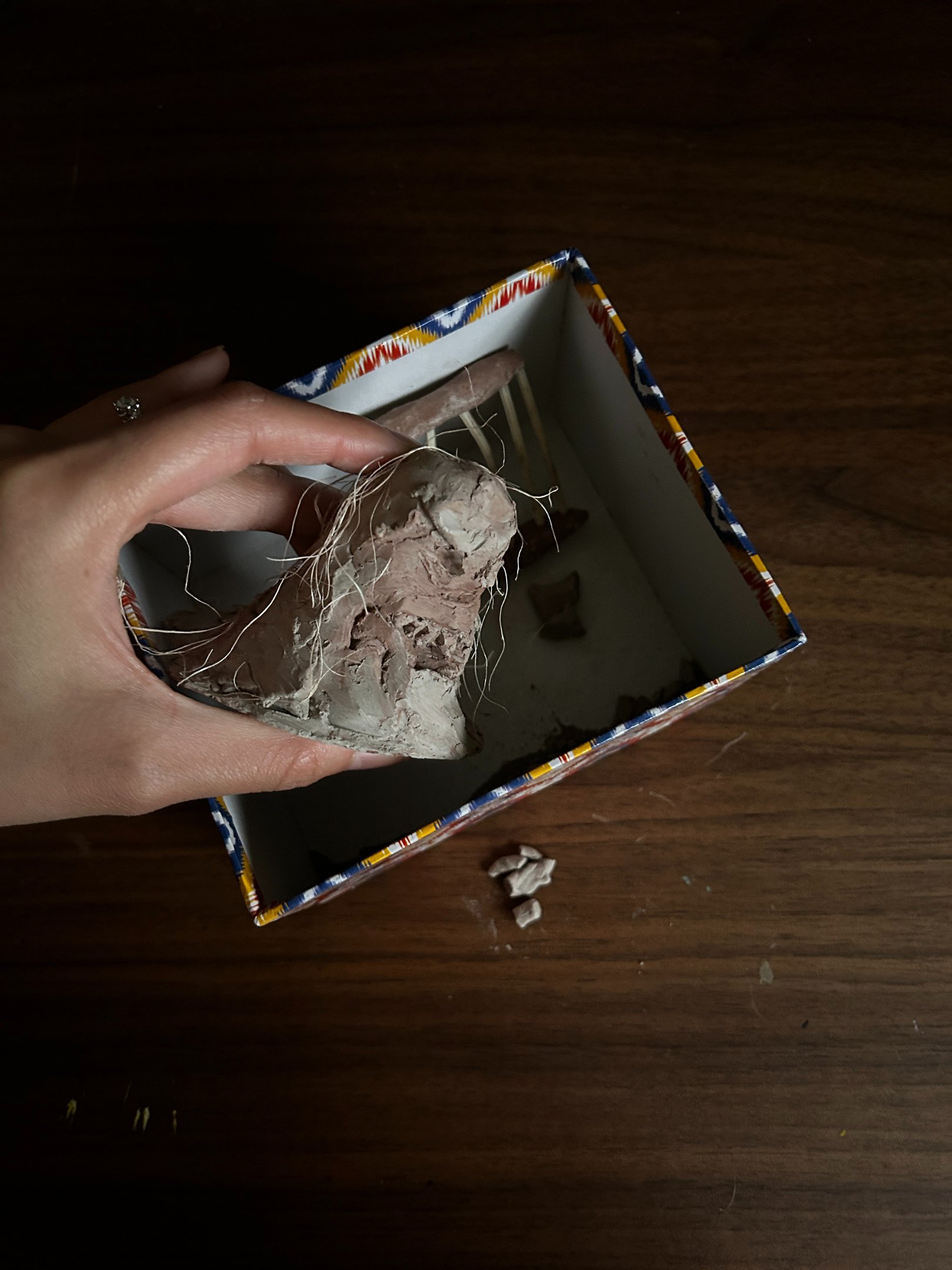 Photo of a broken clay sculpture, resembling fragmented memory and sense of self in older adults.