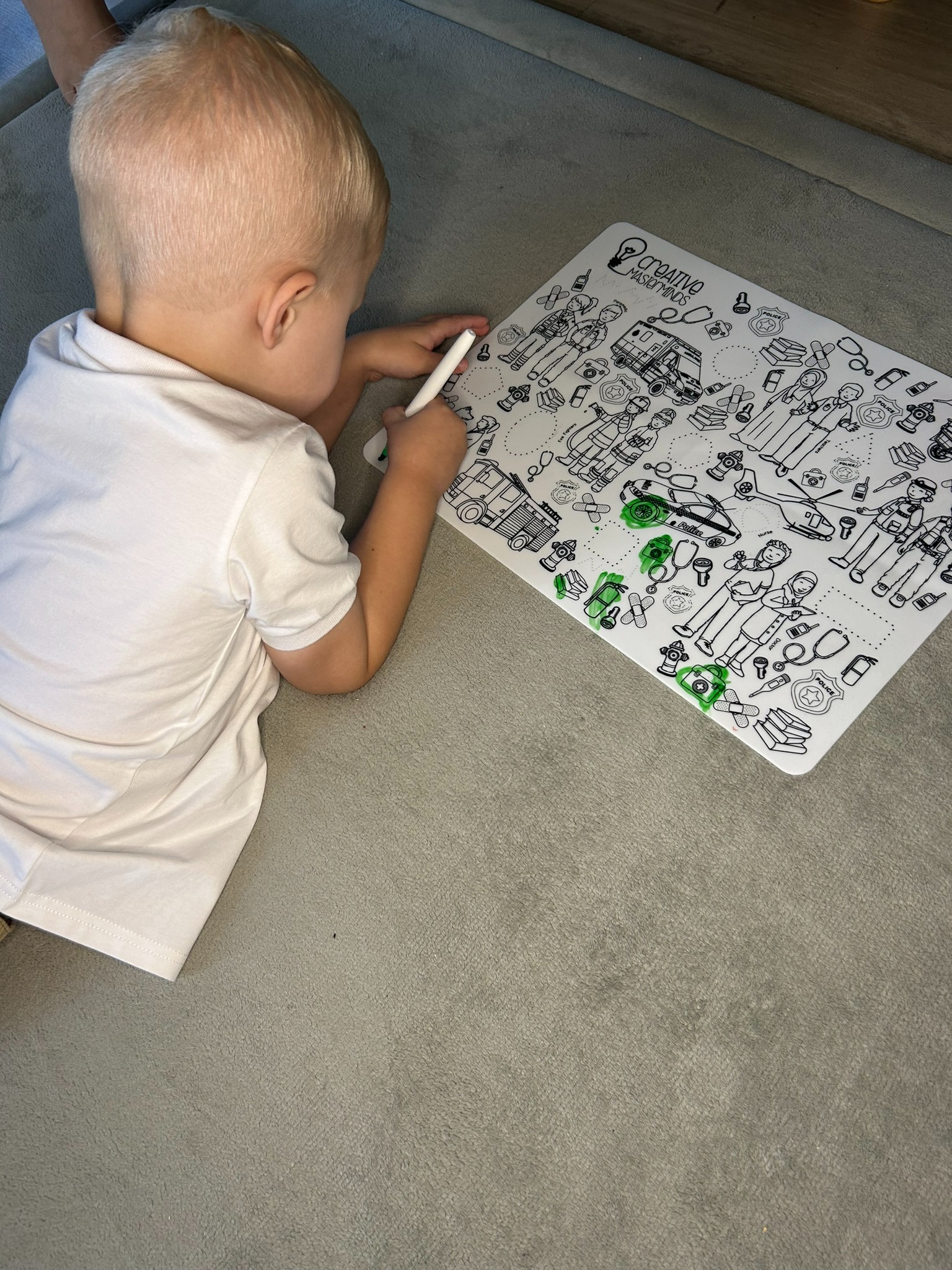 Toddler using a Scribbly Kids reusable drawing mat at home for creativity and screen-free play