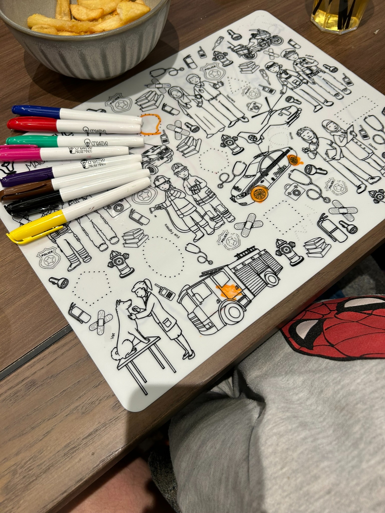 Child learning about doctors and firefighters on Scribbly Kids Community Heroes mat