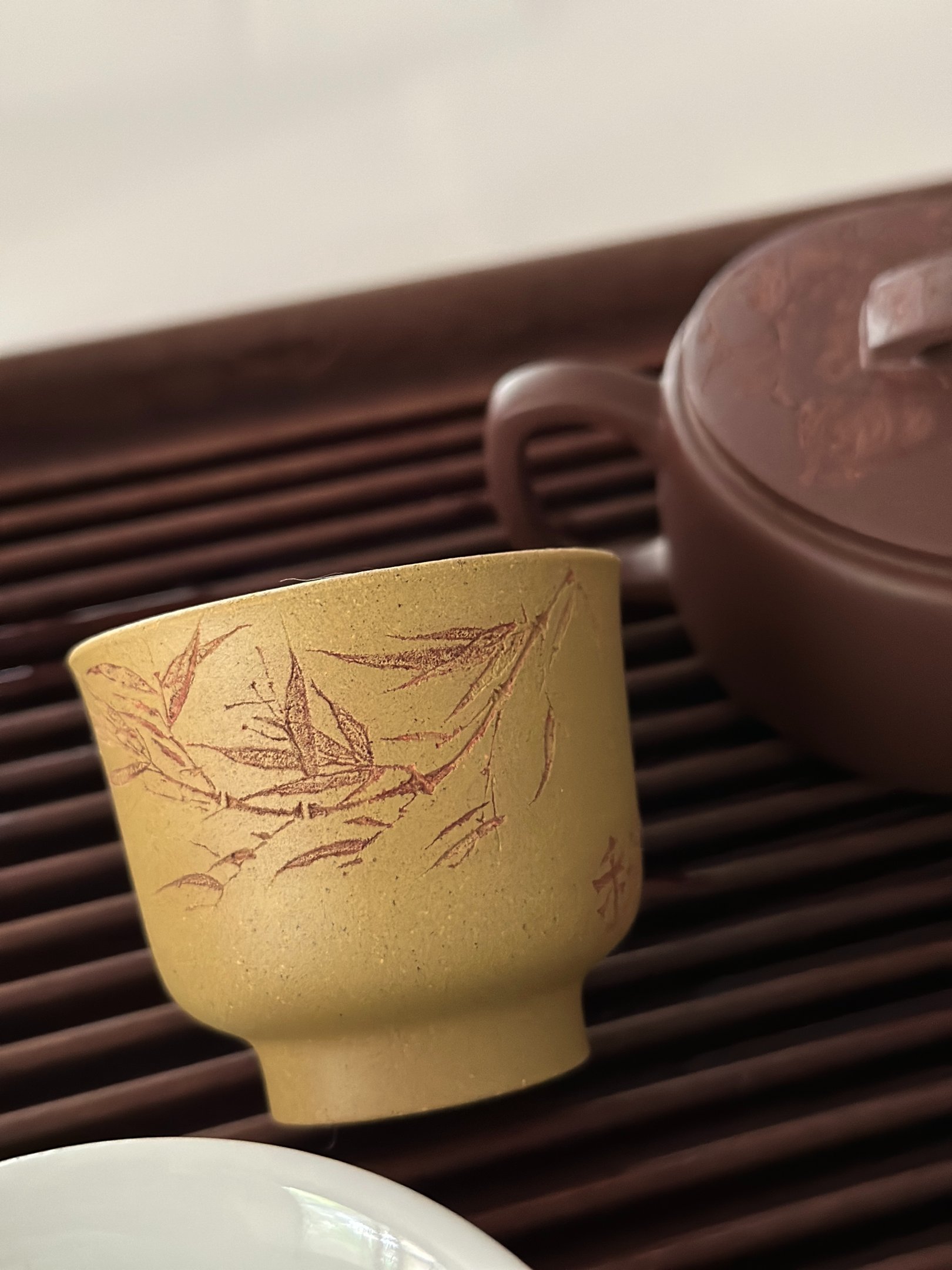 Yellow teacup engraved with artwork