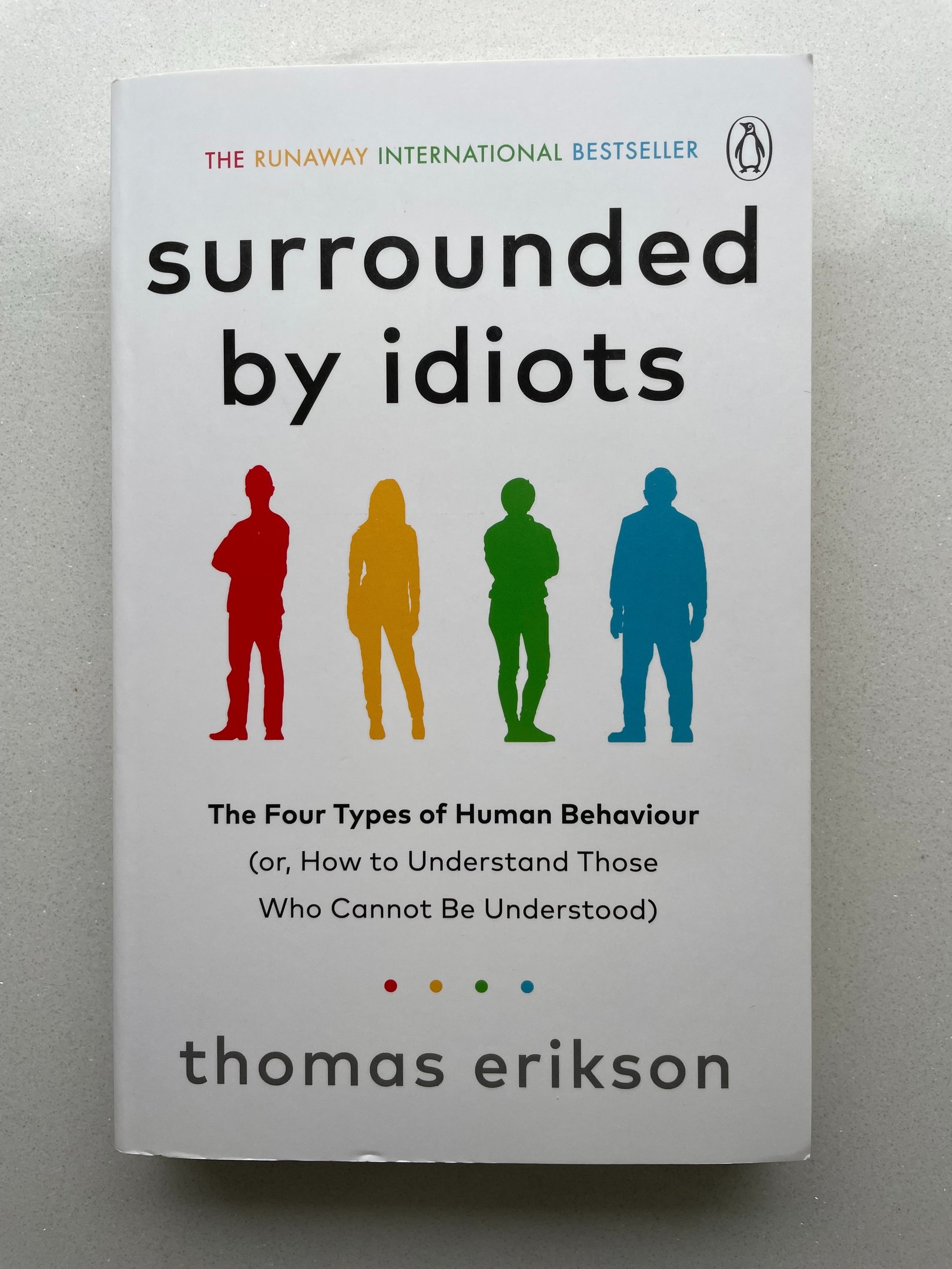 a book cover of Surrounded by idiots