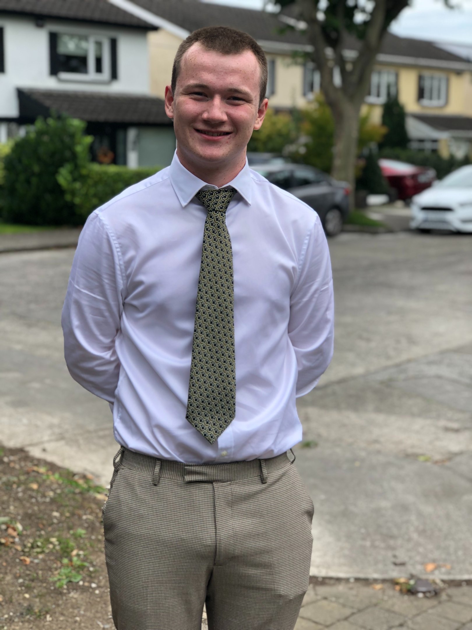 a man in a white shirt and tie dye on a tie