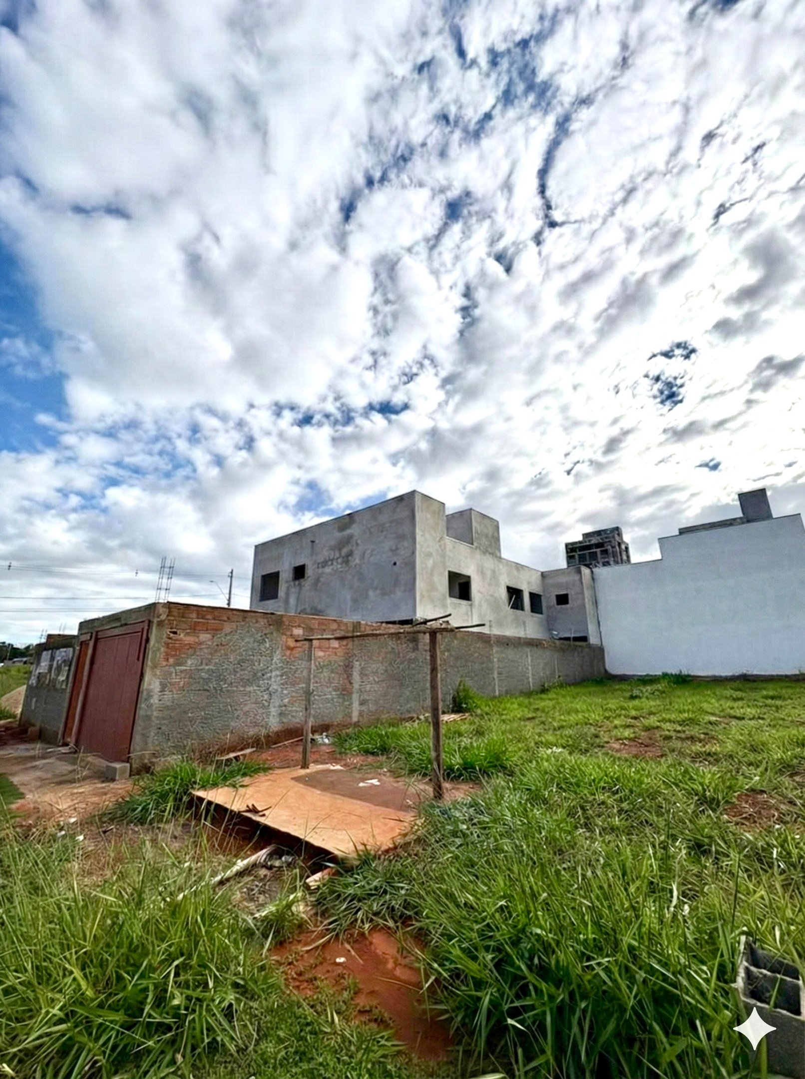 a building with a fenced in area with grass