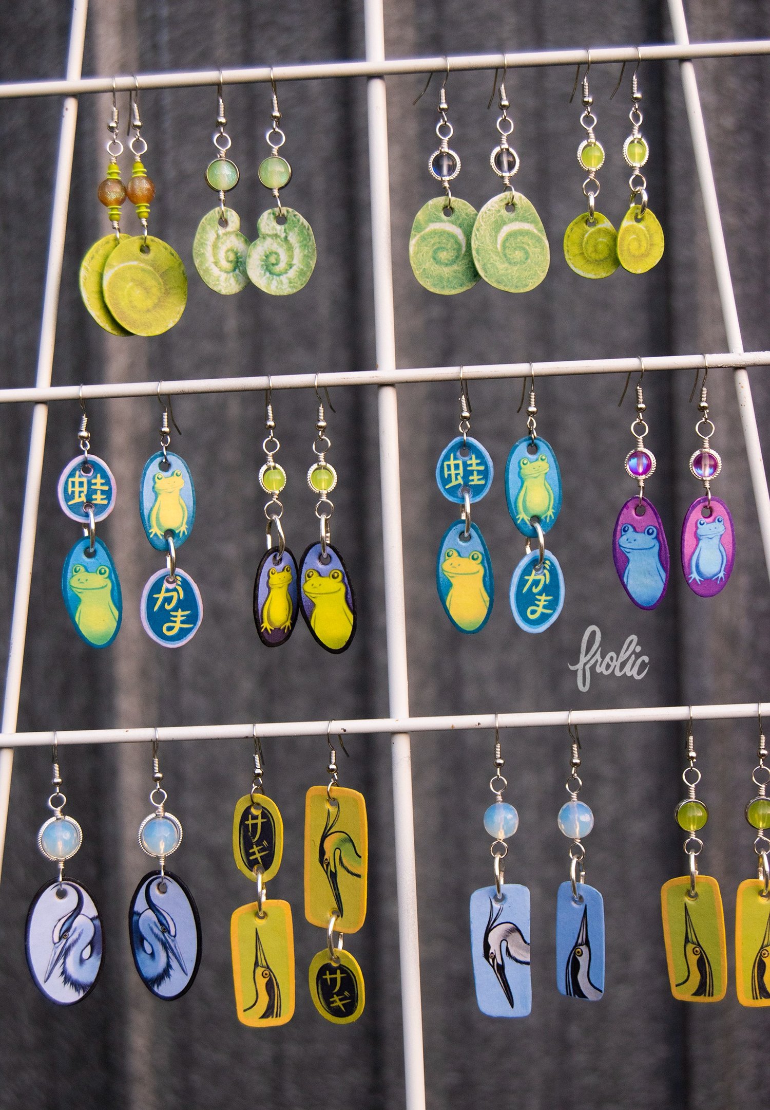 Durable "paper" jewelry featuring tiny artworks. Each is tediously handmade.