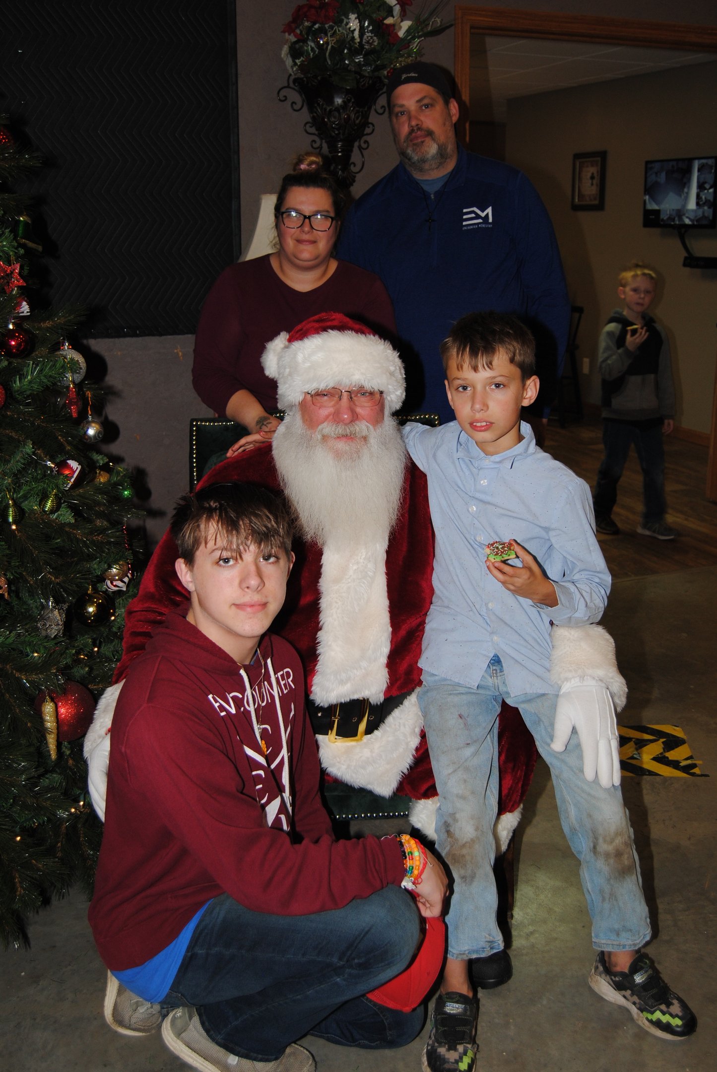 Santa Tom with Family by Christmas Tree