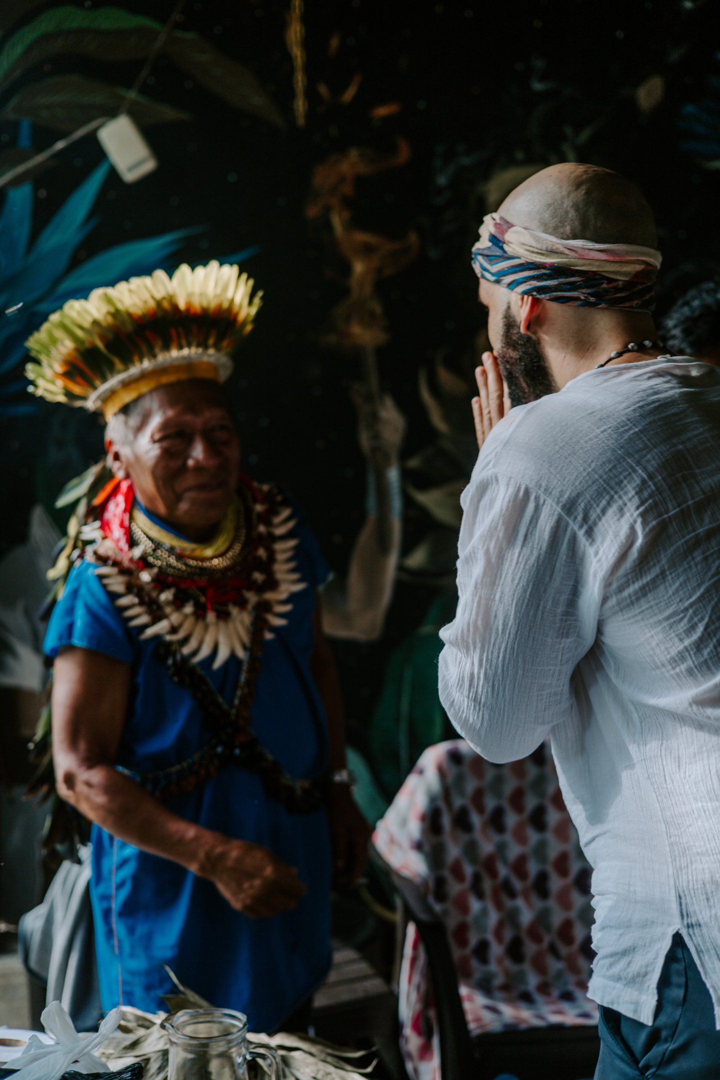 A participant from Mira retreats showing reverence to an indigenous shaman and leader