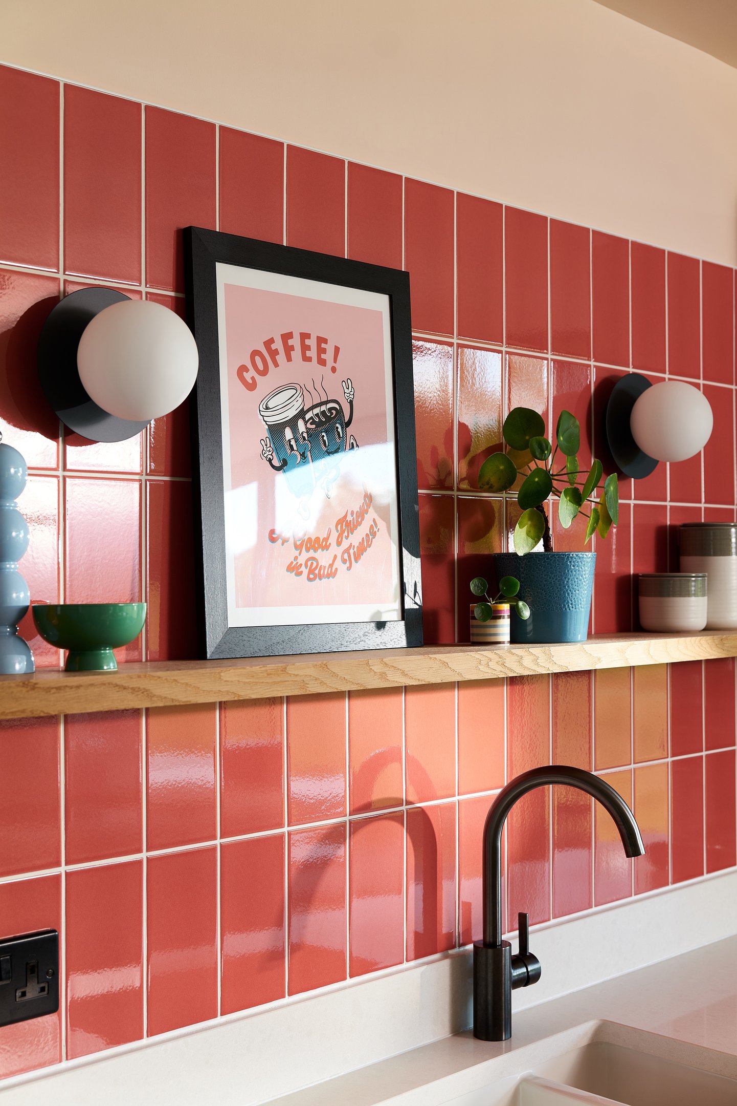 Glossy coral wall tiles with white grout in a modern kitchen splashback, featuring pastel pink