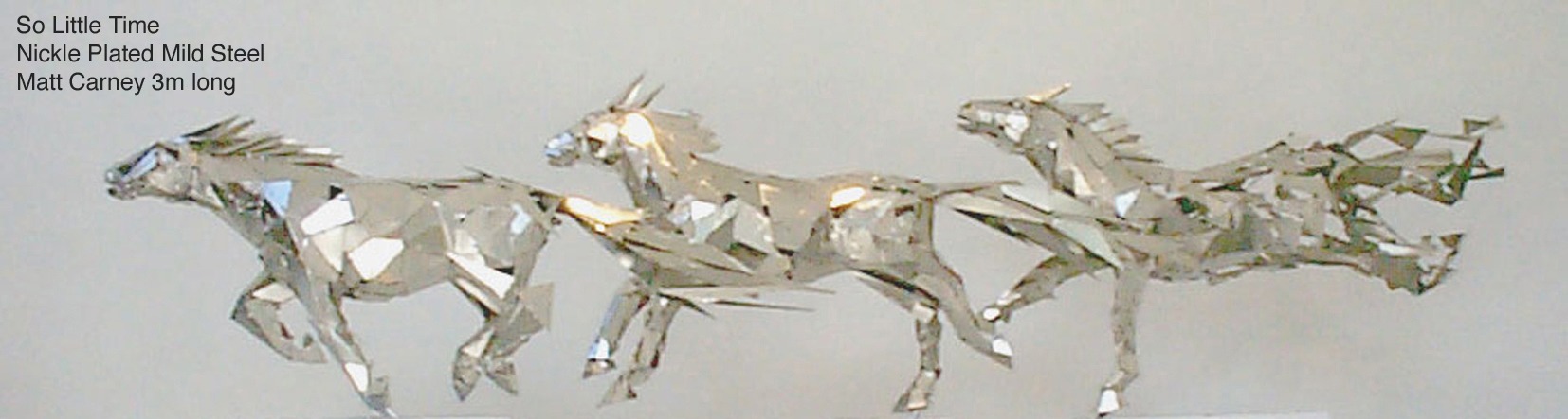 a group of silver horses galloping, with the last becoming pixelated