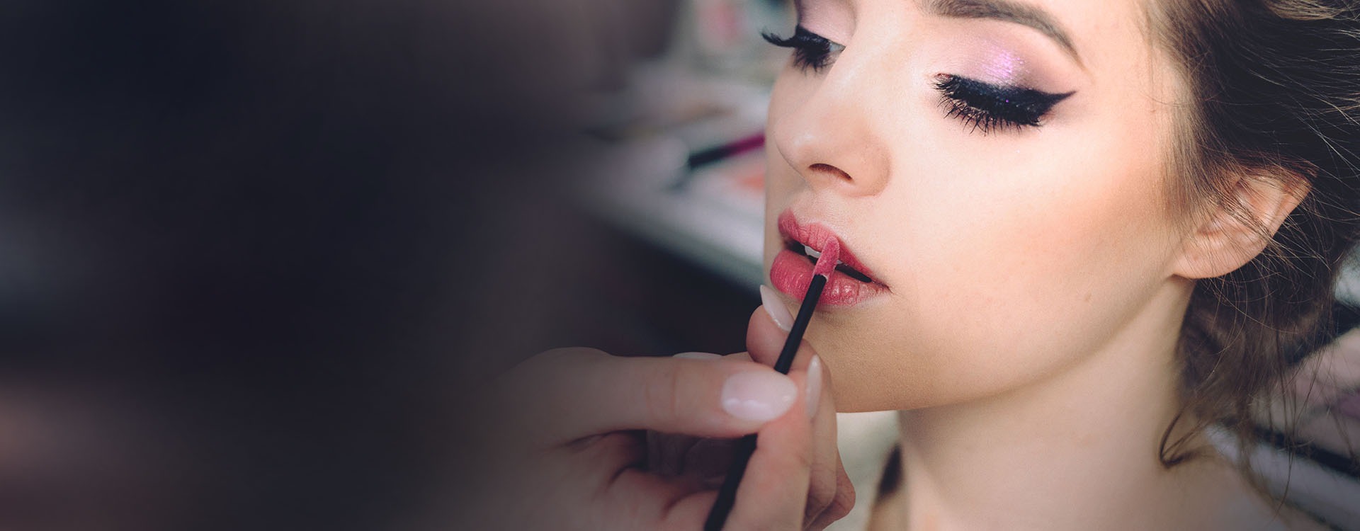 women recieving cosmetic application  of lipstick and facial