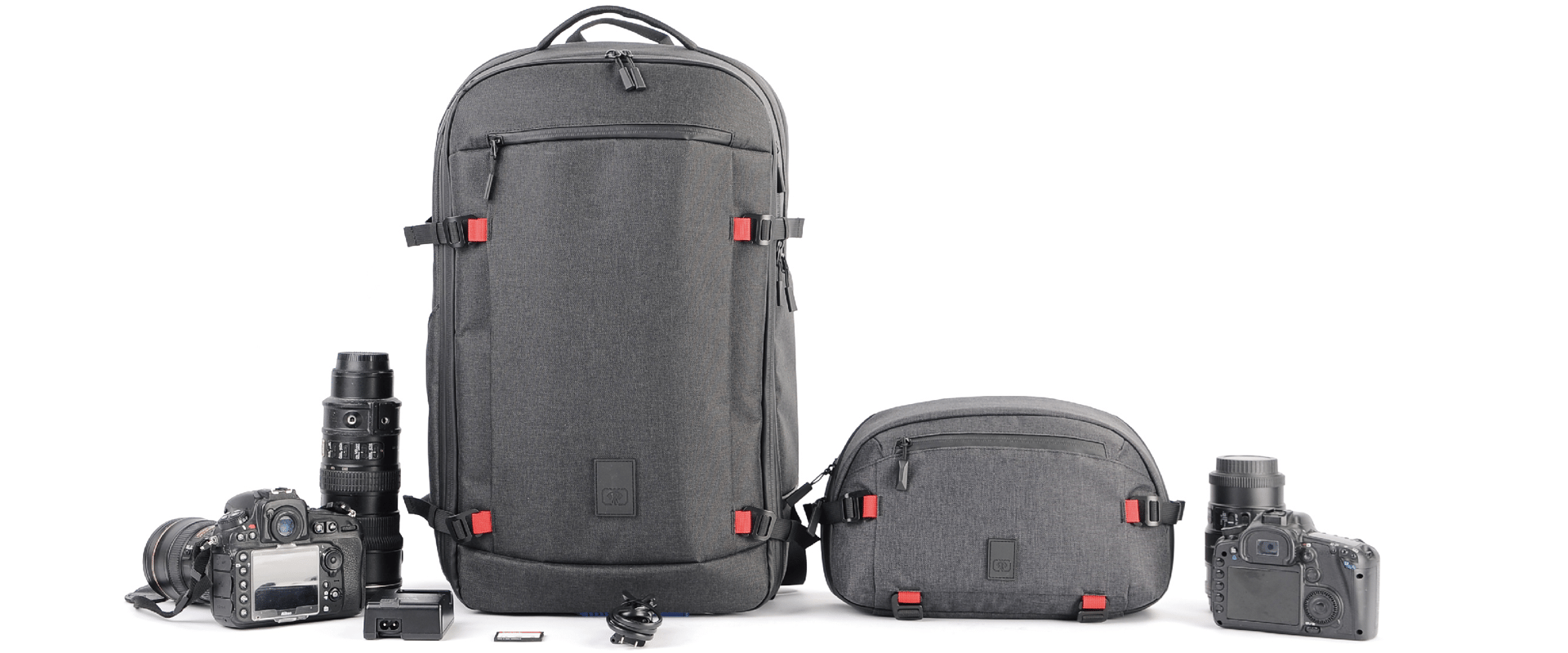 A photography gear set featuring a large dark gray backpack, a smaller matching bag.