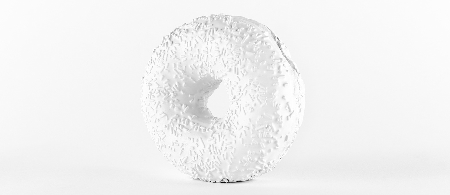 a white sculpture of a large white donut