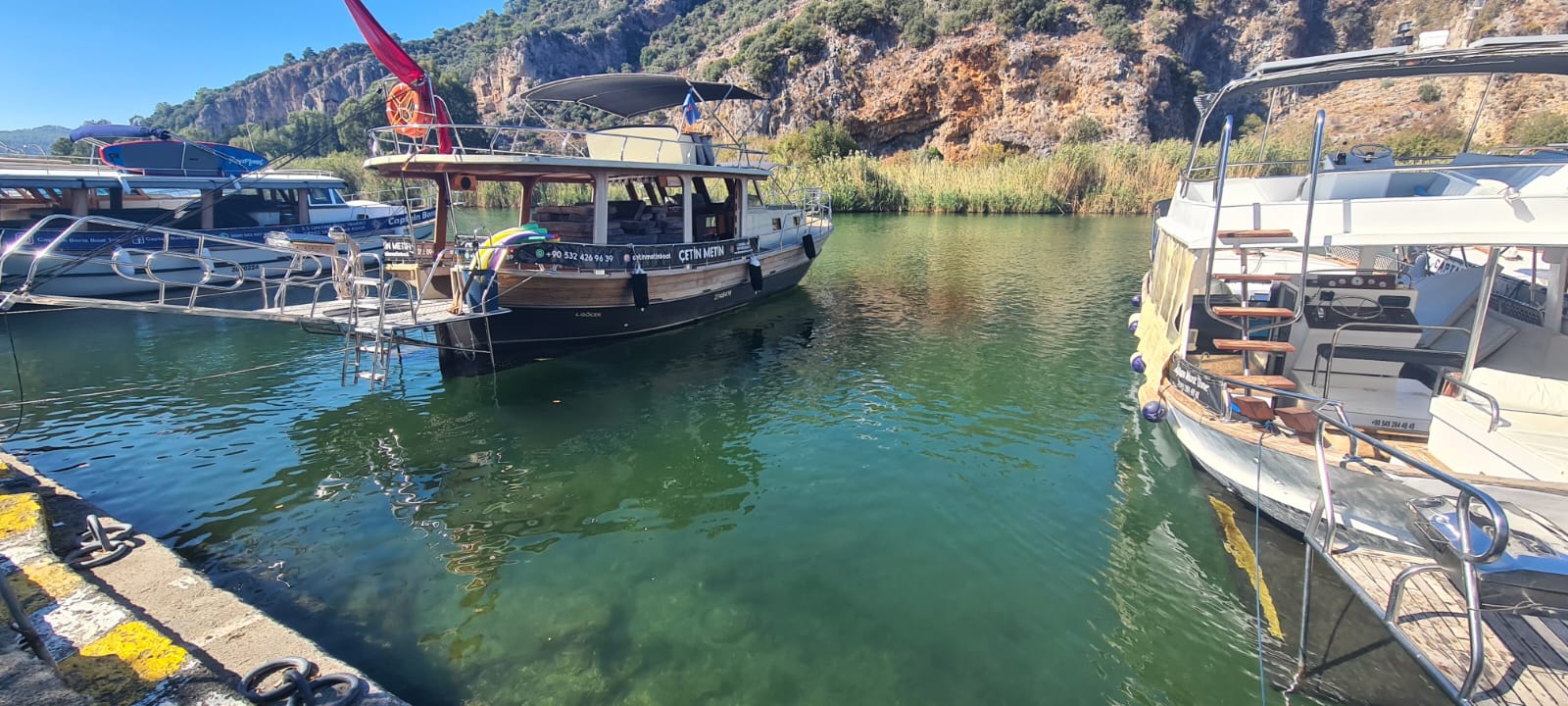 a boat is docked at a dock with a crane