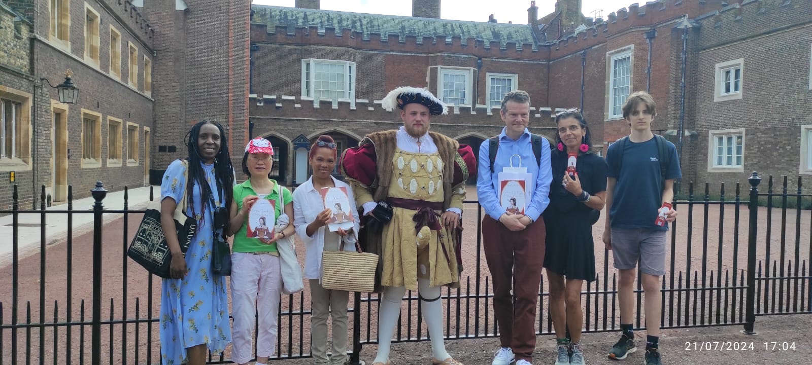 a group of people standing with Henry VIII