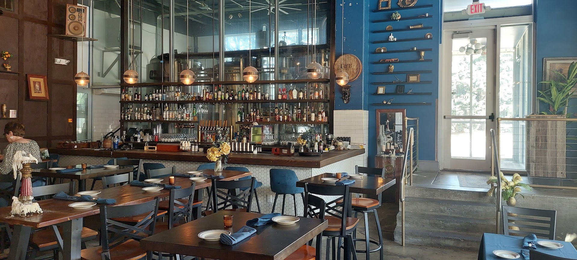 bar at flour & barrel with window behind showing brewing tanks