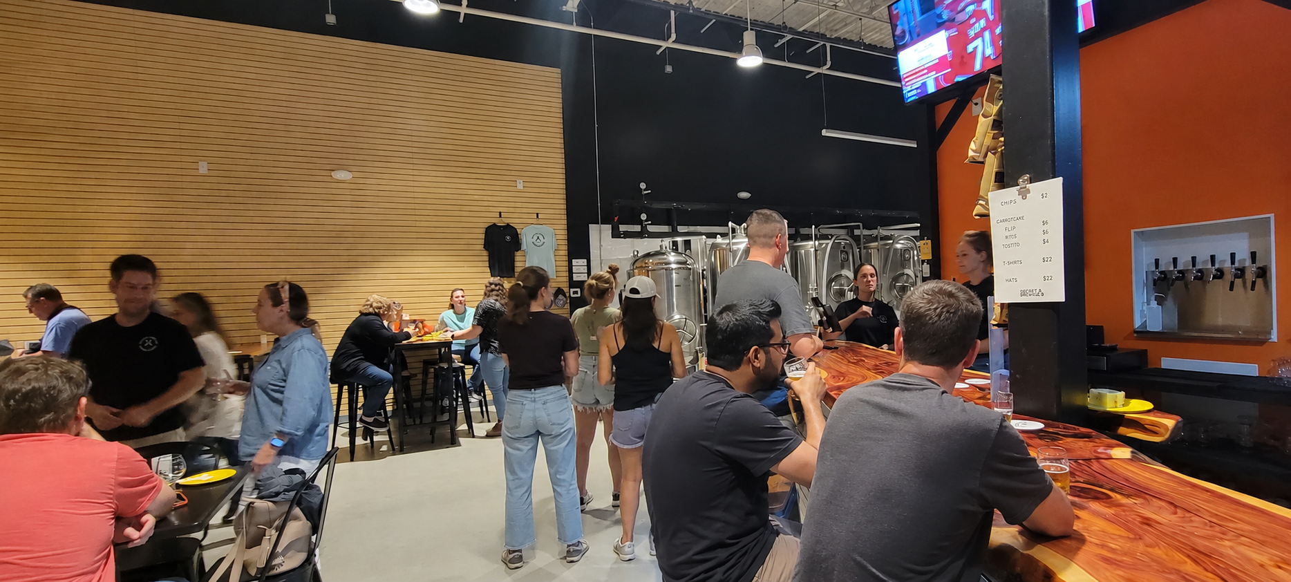 Crowd of people enjoying craft beer at sneaky penguin brewing