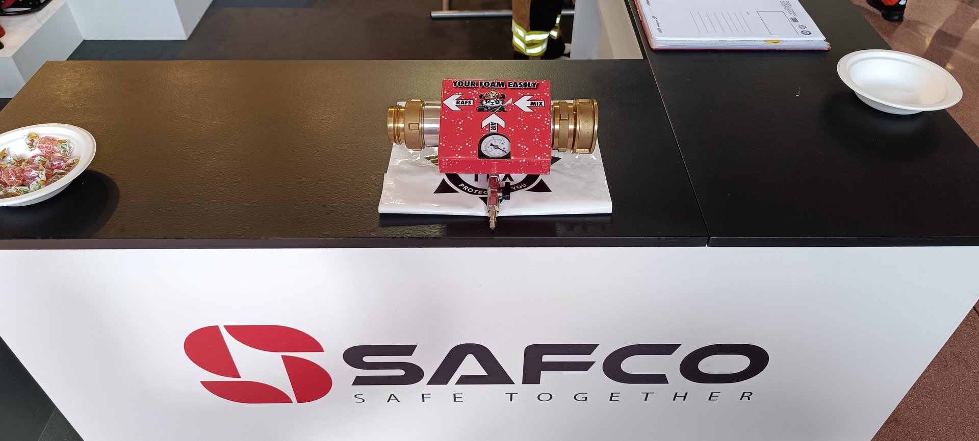 a table with a red RAFS and a white sign that says safco