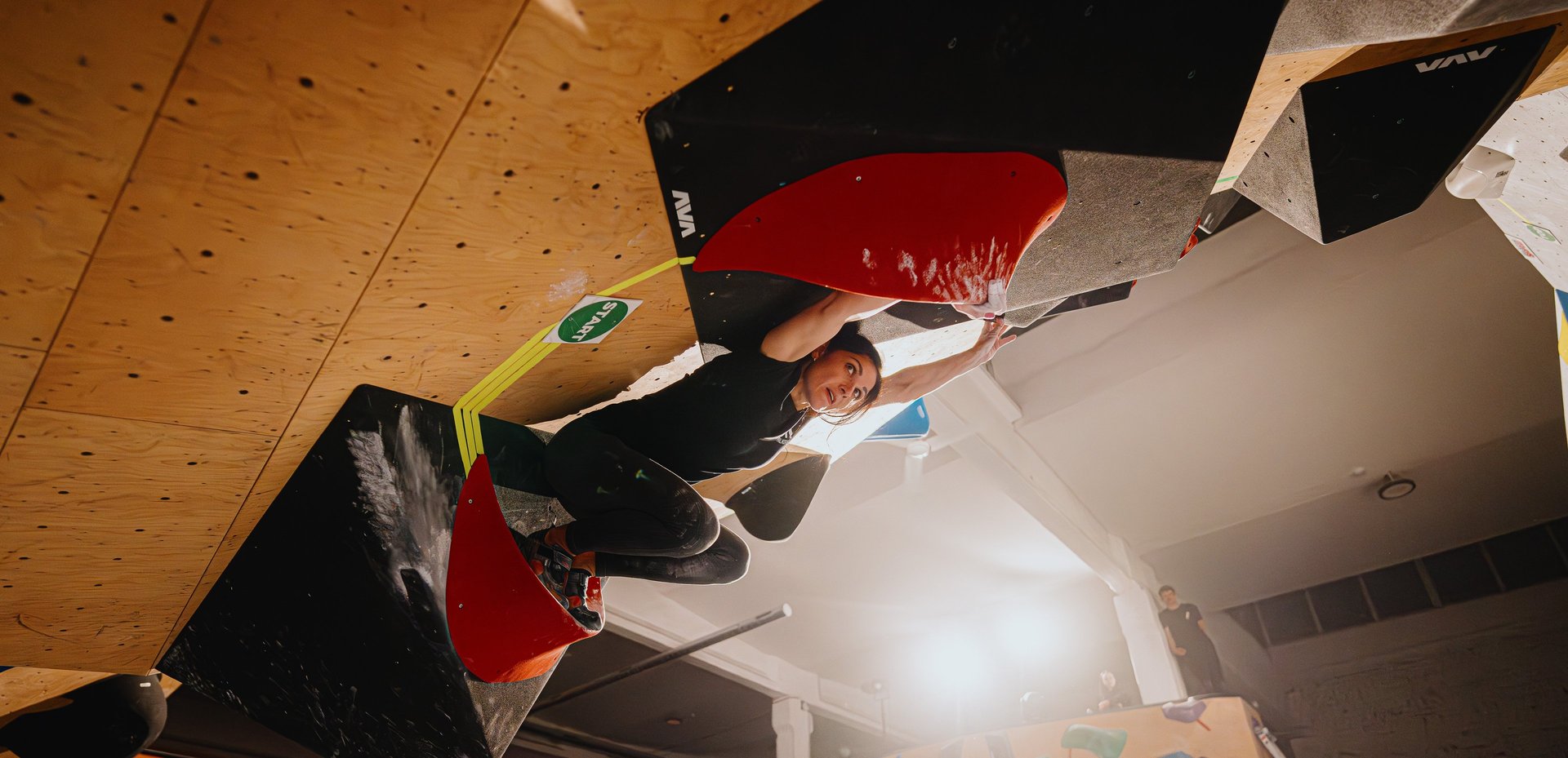 woman climbing in a bouldering competition