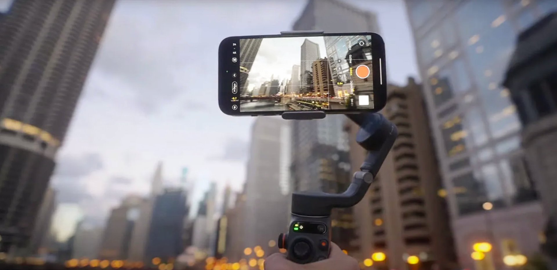 iPhone 14 Pro mounted on a stabilizer, recording cinematic video in an urban setting.