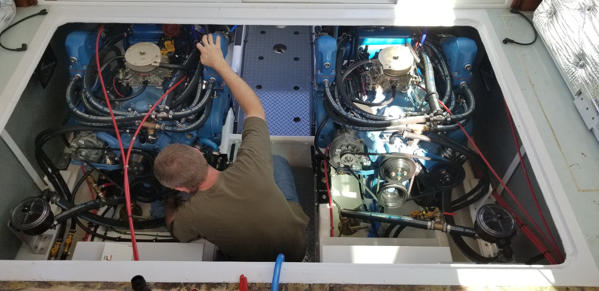 man working in engine room of boat