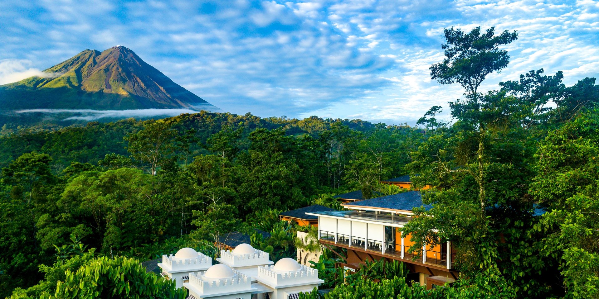 Luxury resort nestled in a lush Costa Rican rainforest with a view of the Arenal Volcano.